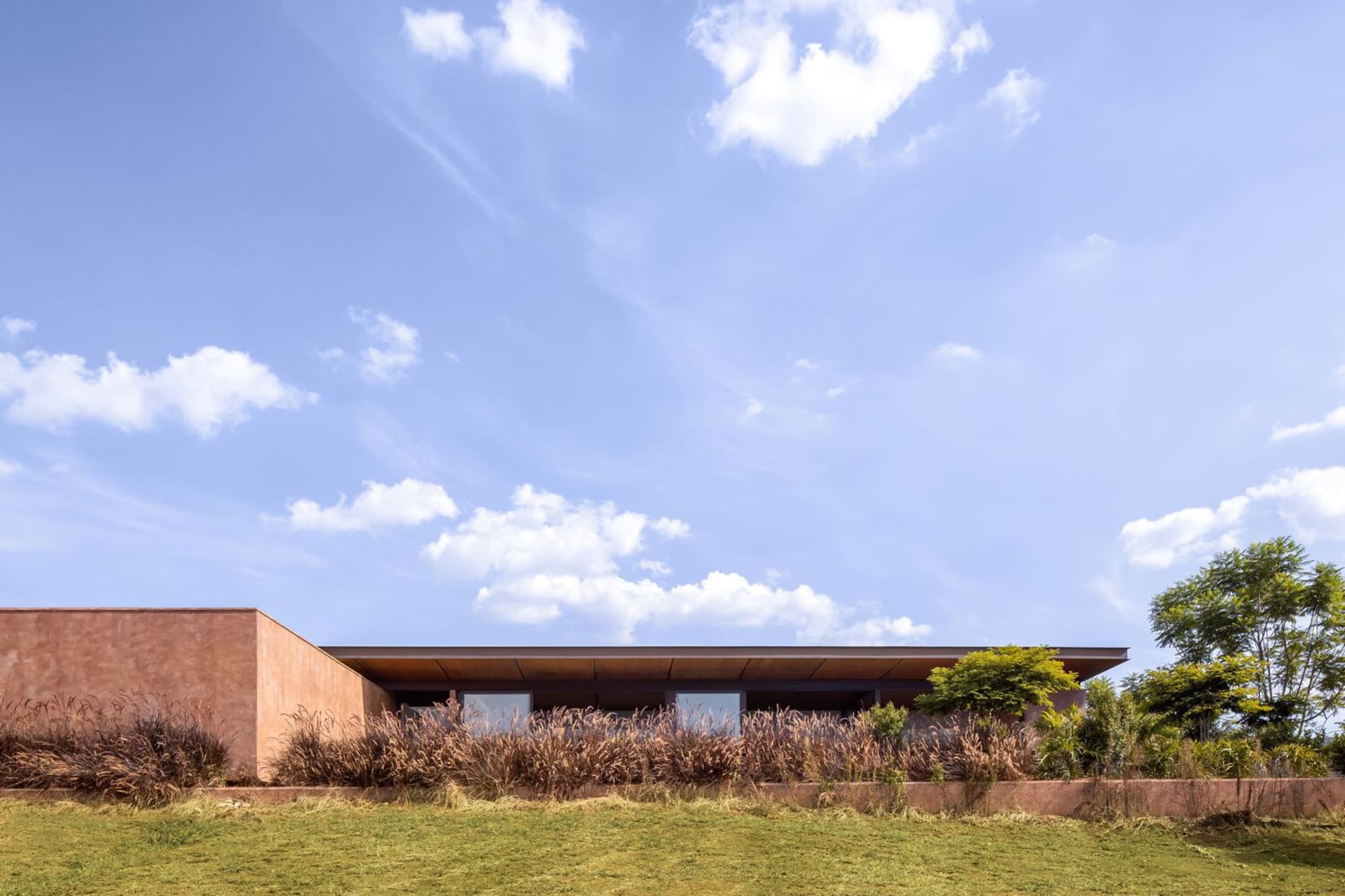 A modern house with a flat roof and concrete exterior.