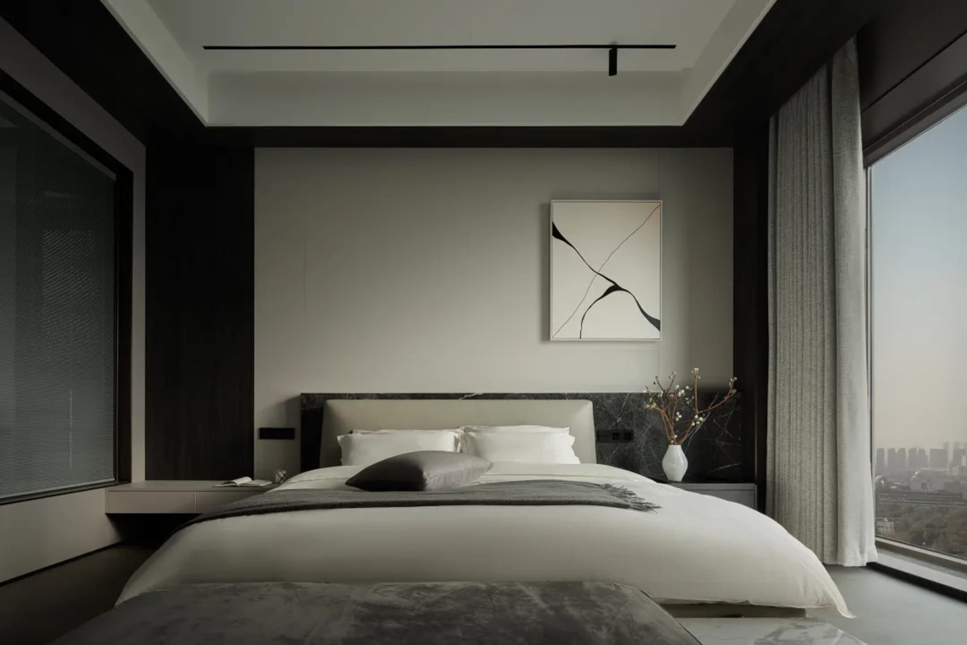 Modern minimalist bedroom featuring a bed with marble headboard, white bedding, and a minimalist artwork on the wall.