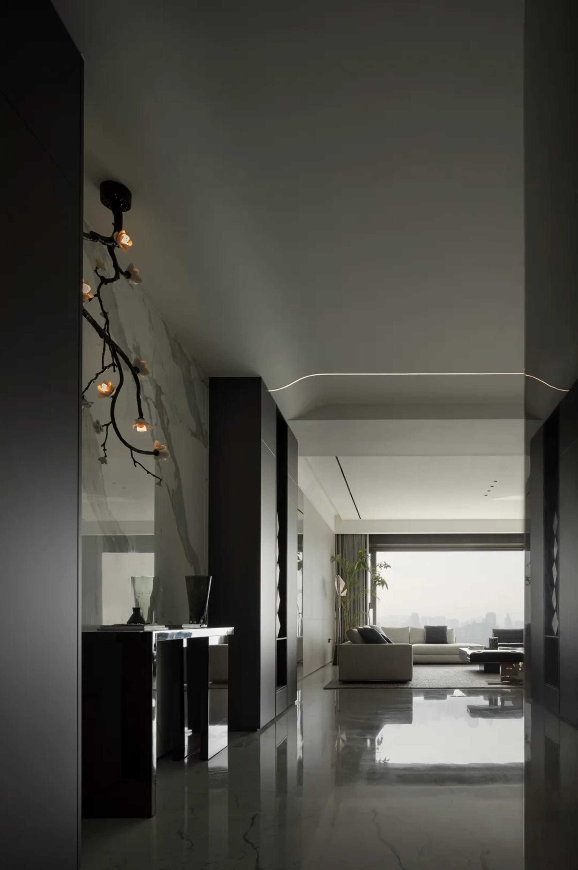 Modern minimalist living room with glass walls and marble flooring.