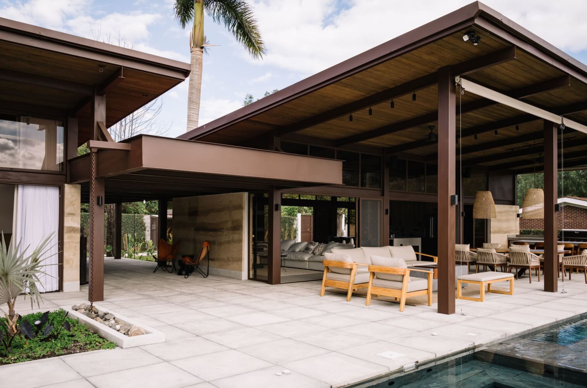 Modern patio space featuring concrete, wood, and glass materials.