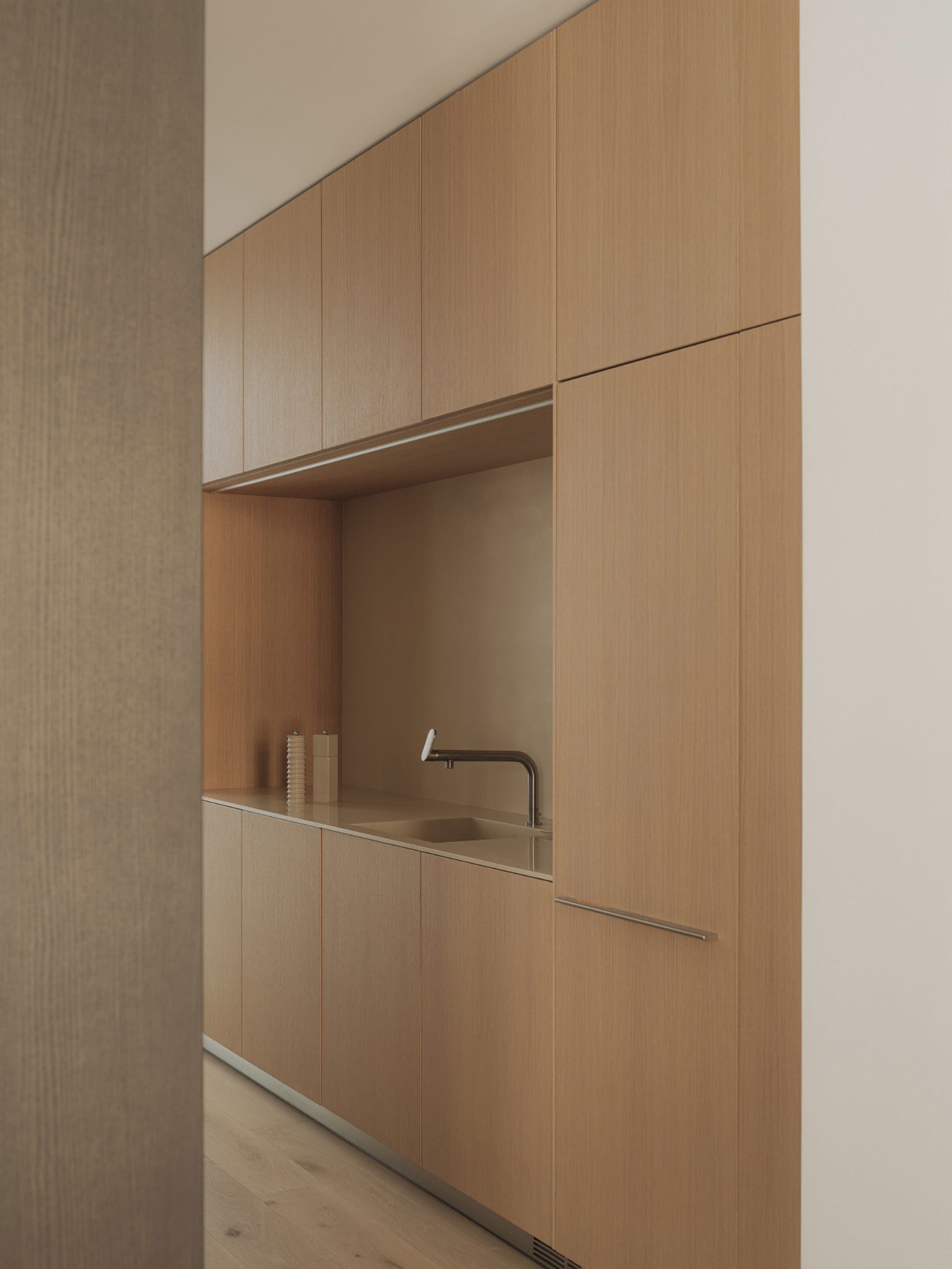 Modern residential kitchen featuring wooden cabinets and sleek design elements.
