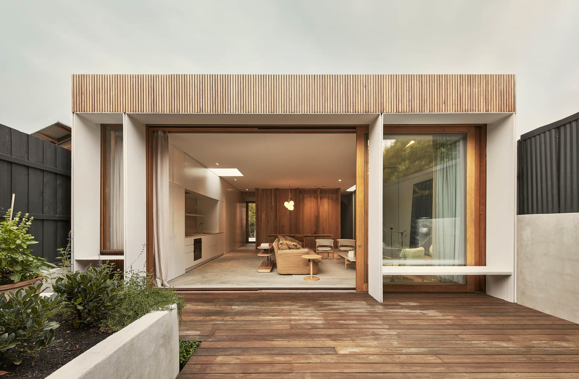 A modern, minimalist exterior with wooden panels and glass windows.