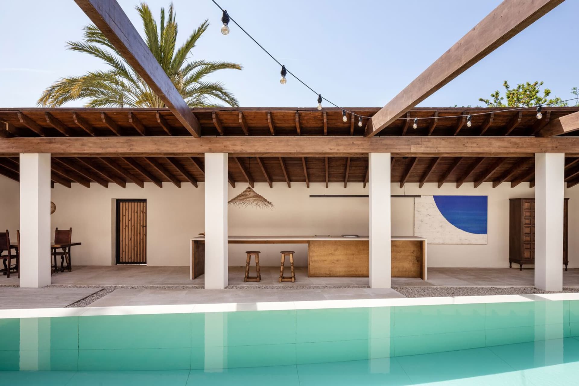 Modern residential interior featuring wooden elements and a swimming pool.