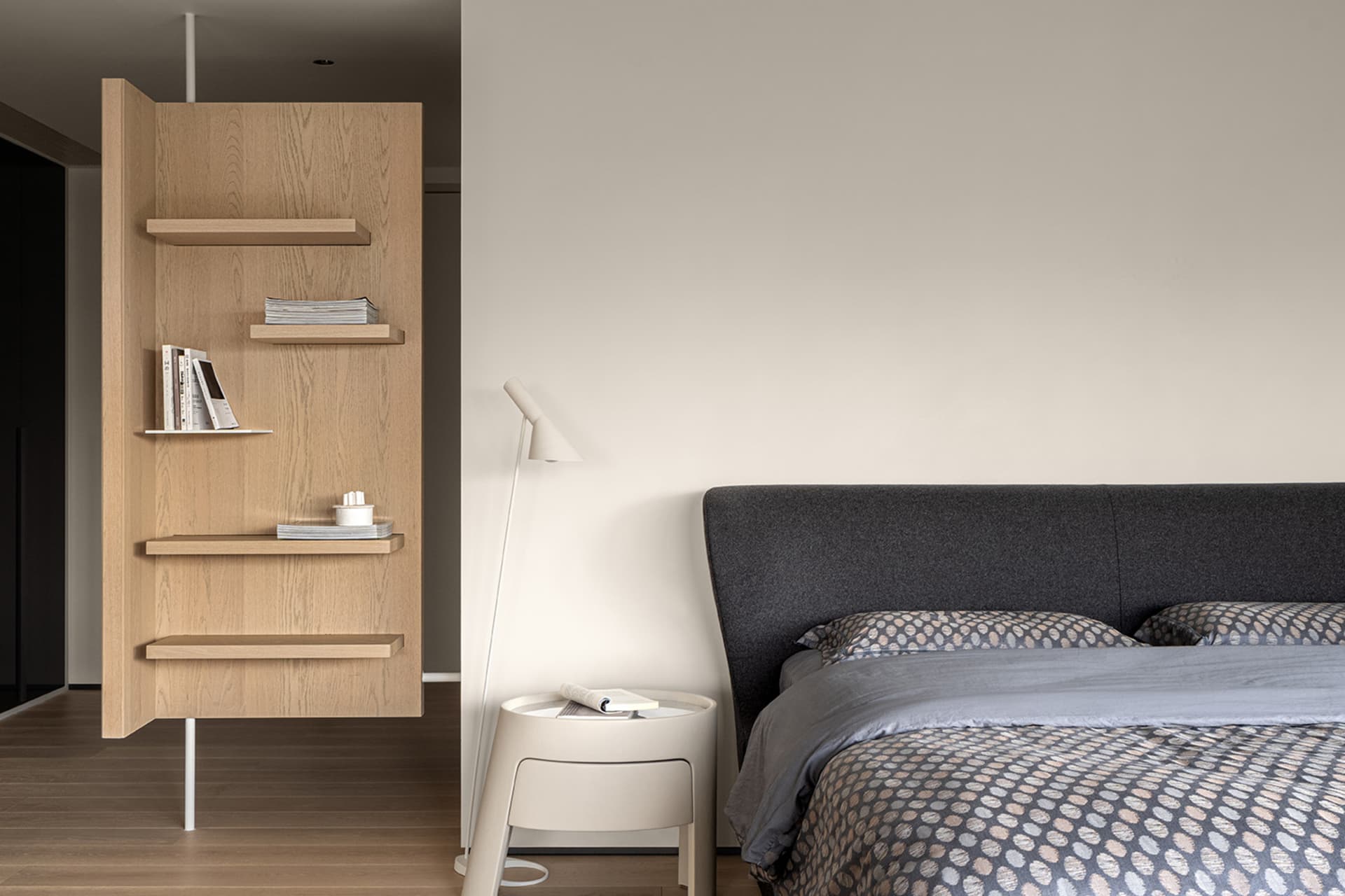 Modern minimalist bedroom featuring wood furniture, fabric bedding, and metal accents.