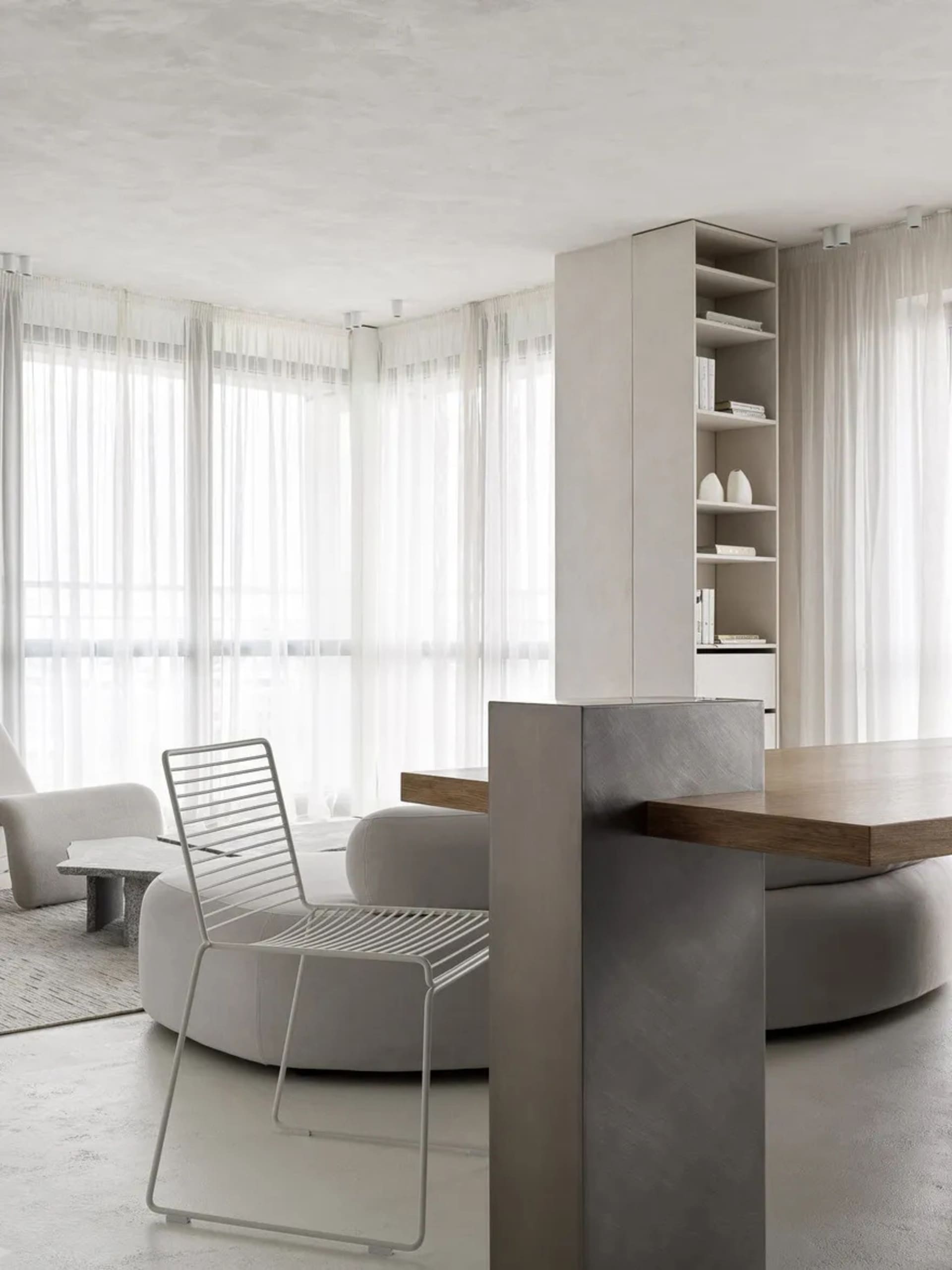 Contemporary living room featuring modern minimalist design, wooden furniture, metal accents, and fabric seating.