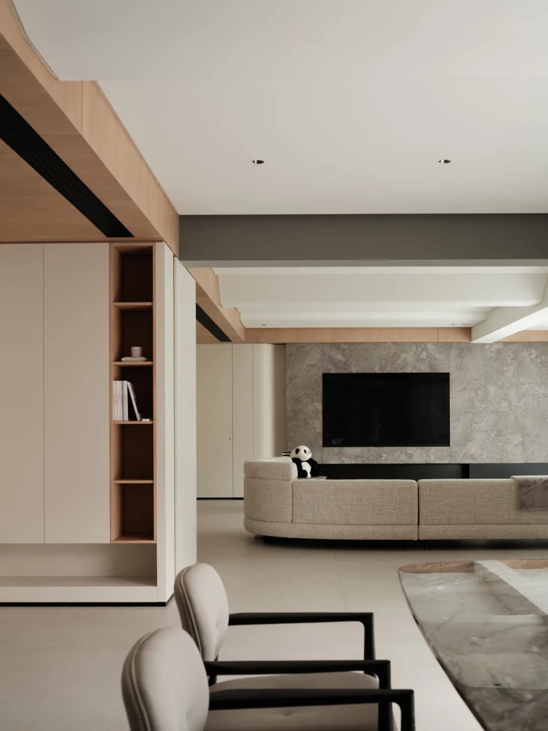 A modern living room featuring minimalist design with concrete walls, marble accents, and a fabric sofa.
