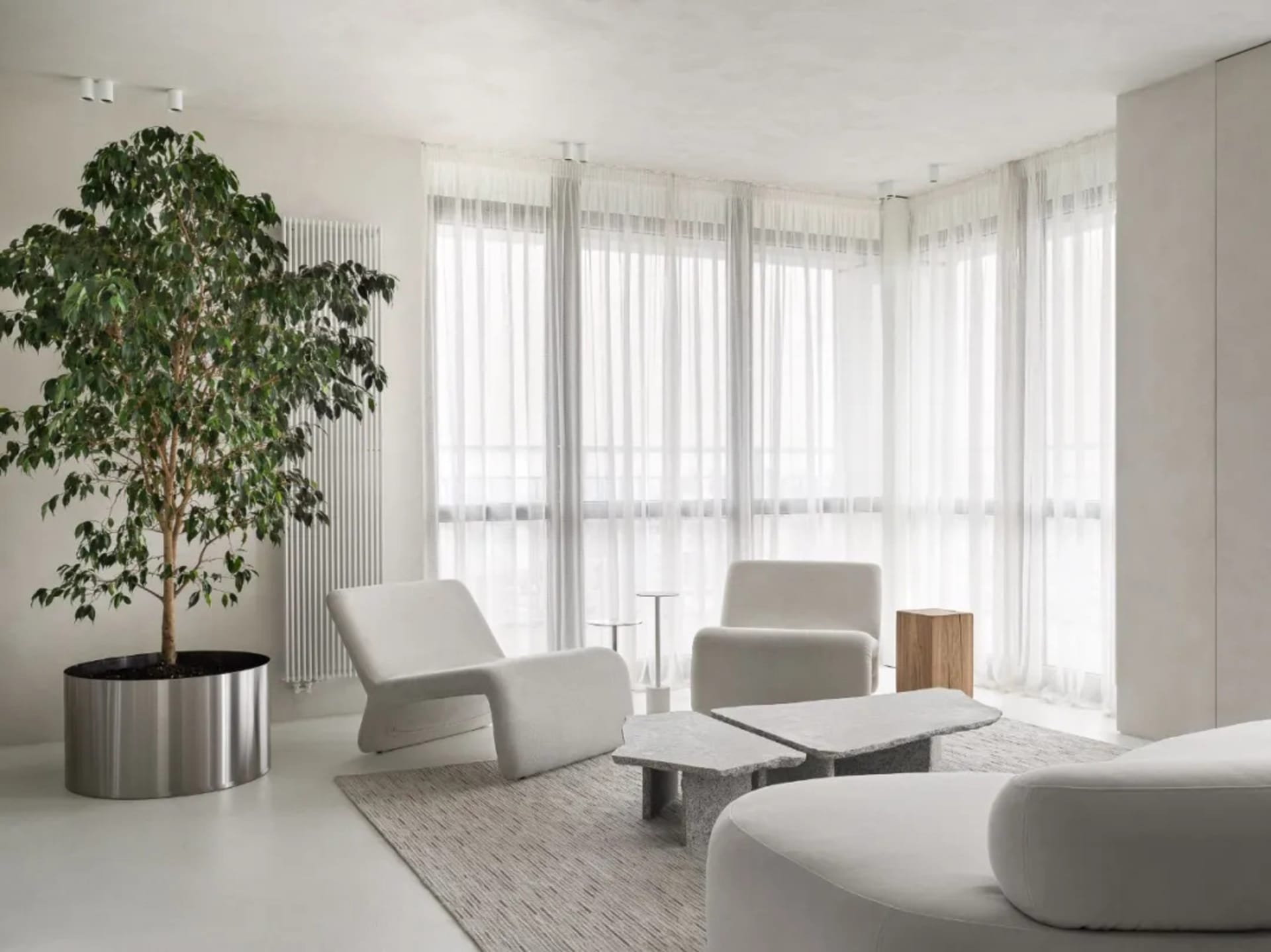 Modern living room featuring neutral-tones furniture and minimalistic decor.