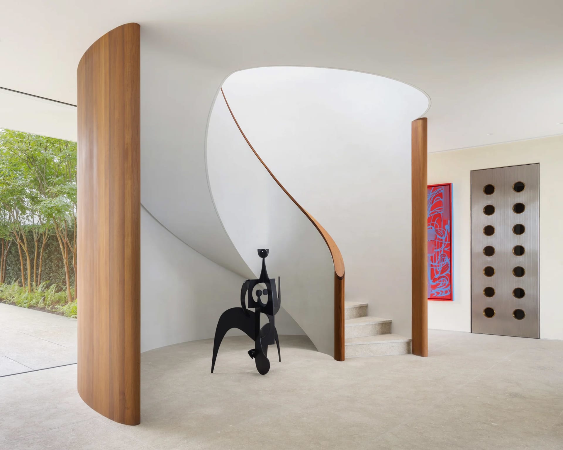 Modern concrete staircase with wooden accents and abstract artwork.