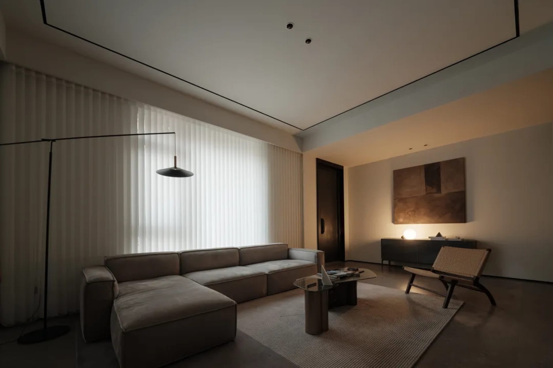 A modern, neutral-toned living room with minimalist design elements.