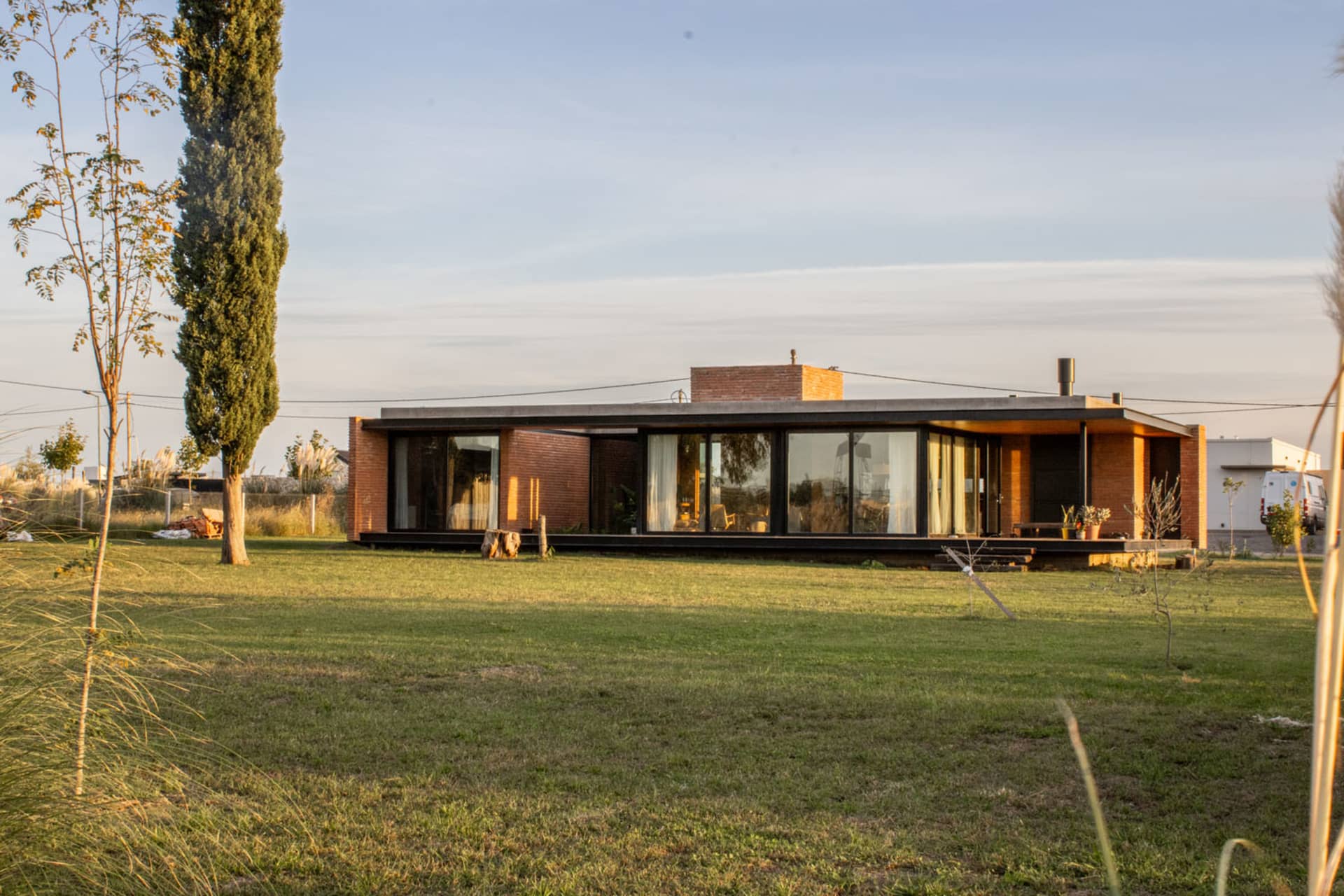 A modern house with brick and glass exterior features.