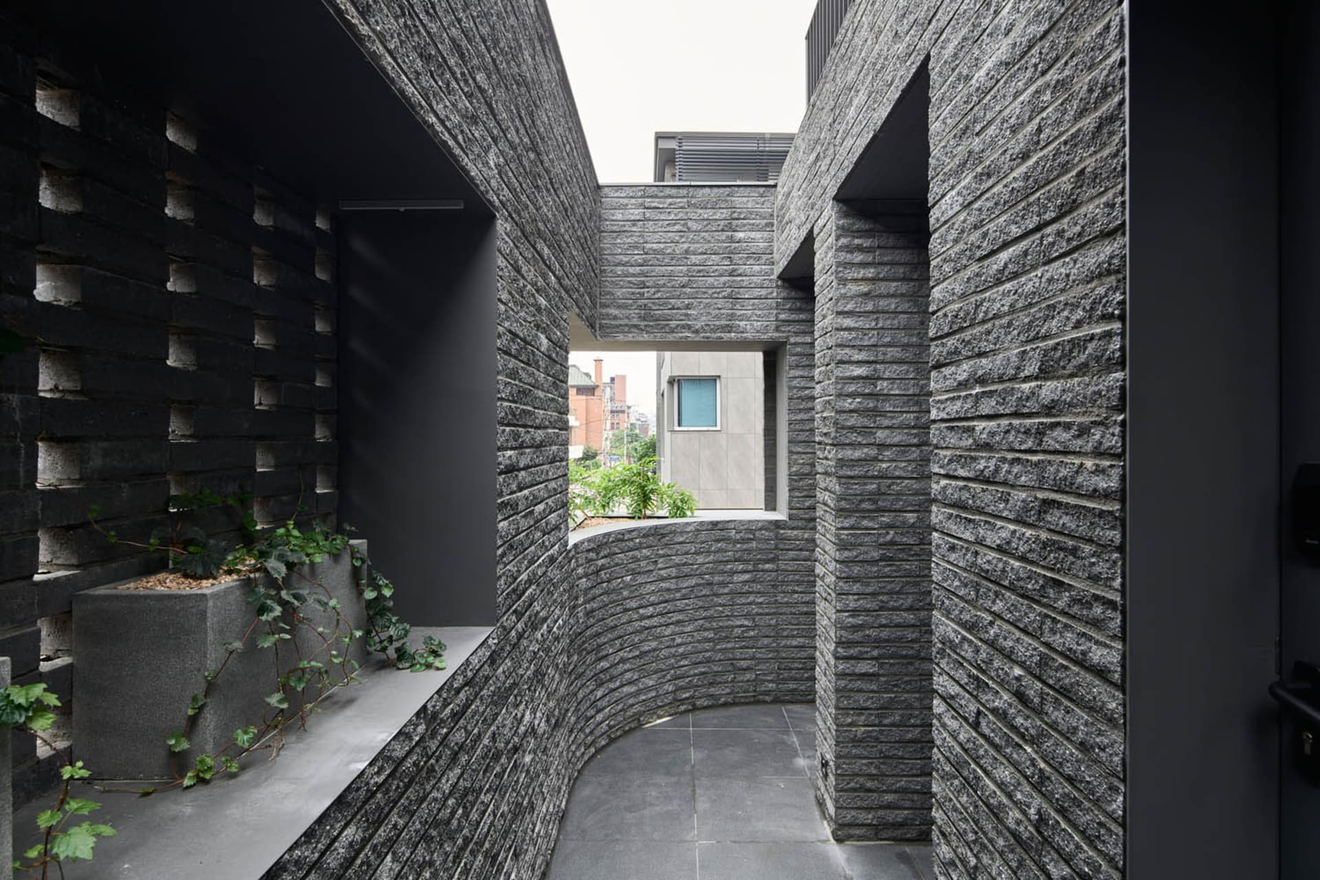 A photograph of a modern interior space with concrete walls, showing a minimalist design aesthetic.