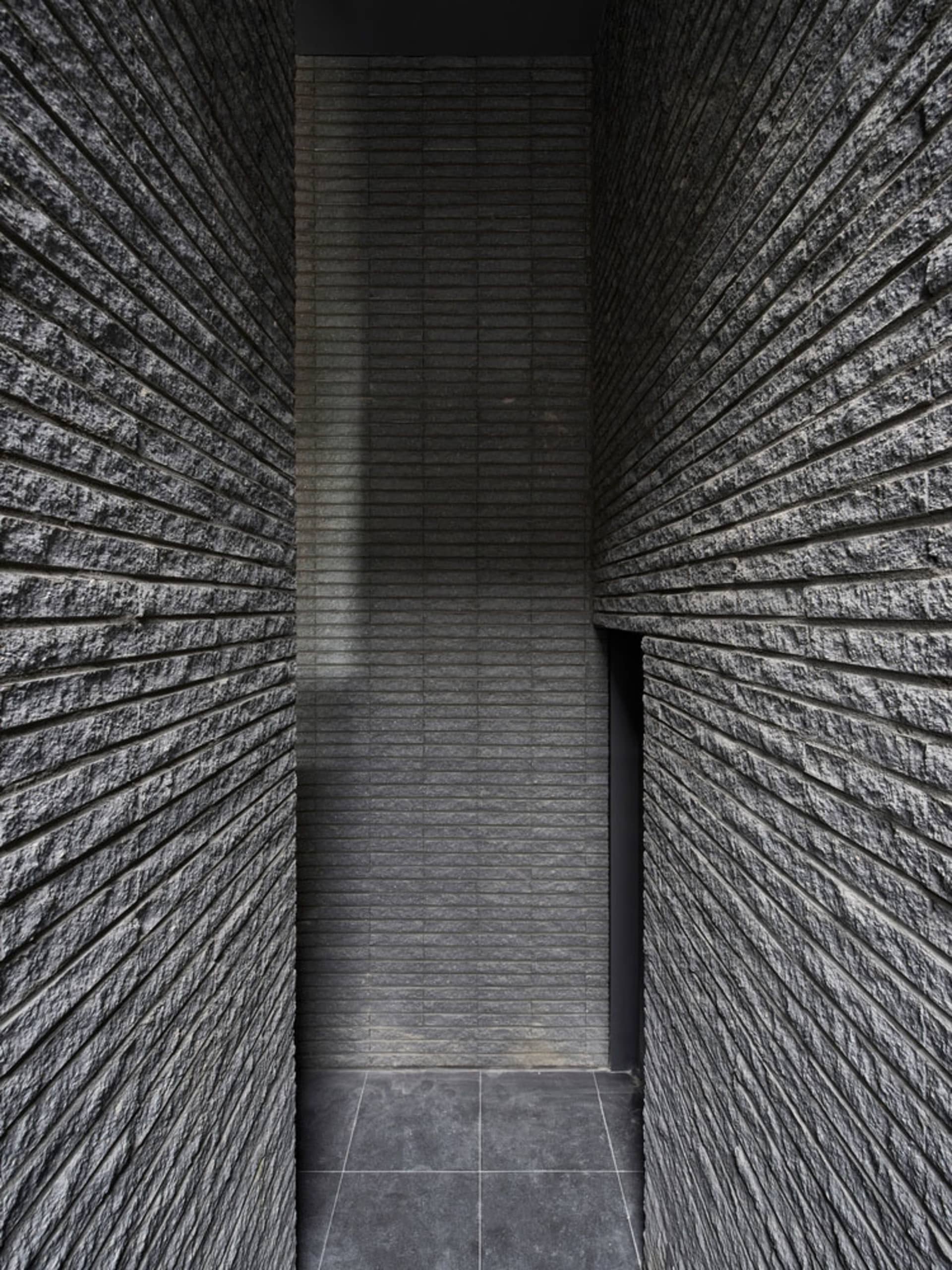 A modern interior space featuring a brick wall.