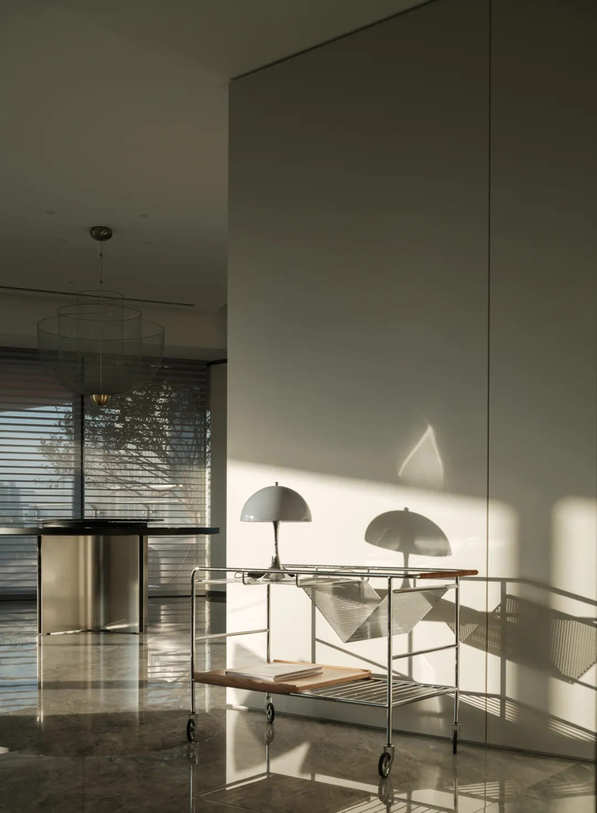 A modern interior featuring minimalist lighting fixtures with wire shades and glossy marble flooring, casting intricate shado