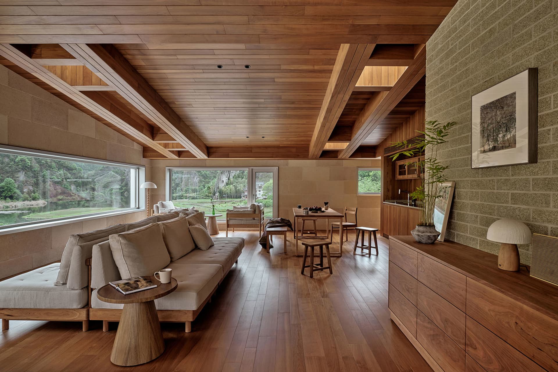 Modern living room featuring wooden flooring, a comfortable sofa, and a view of the outdoors.