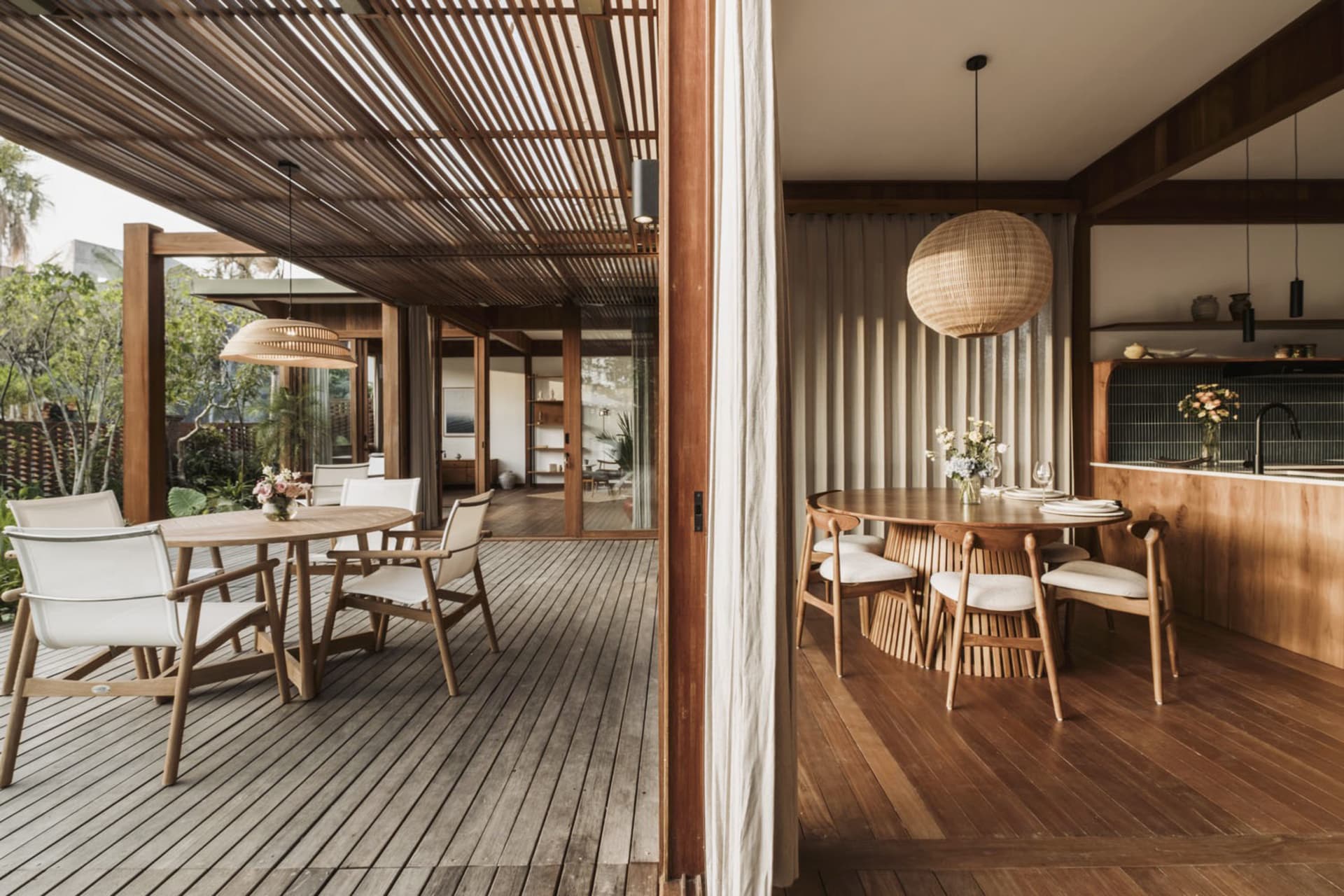 A modern residential dining room featuring wooden furniture and a natural light-filled space.