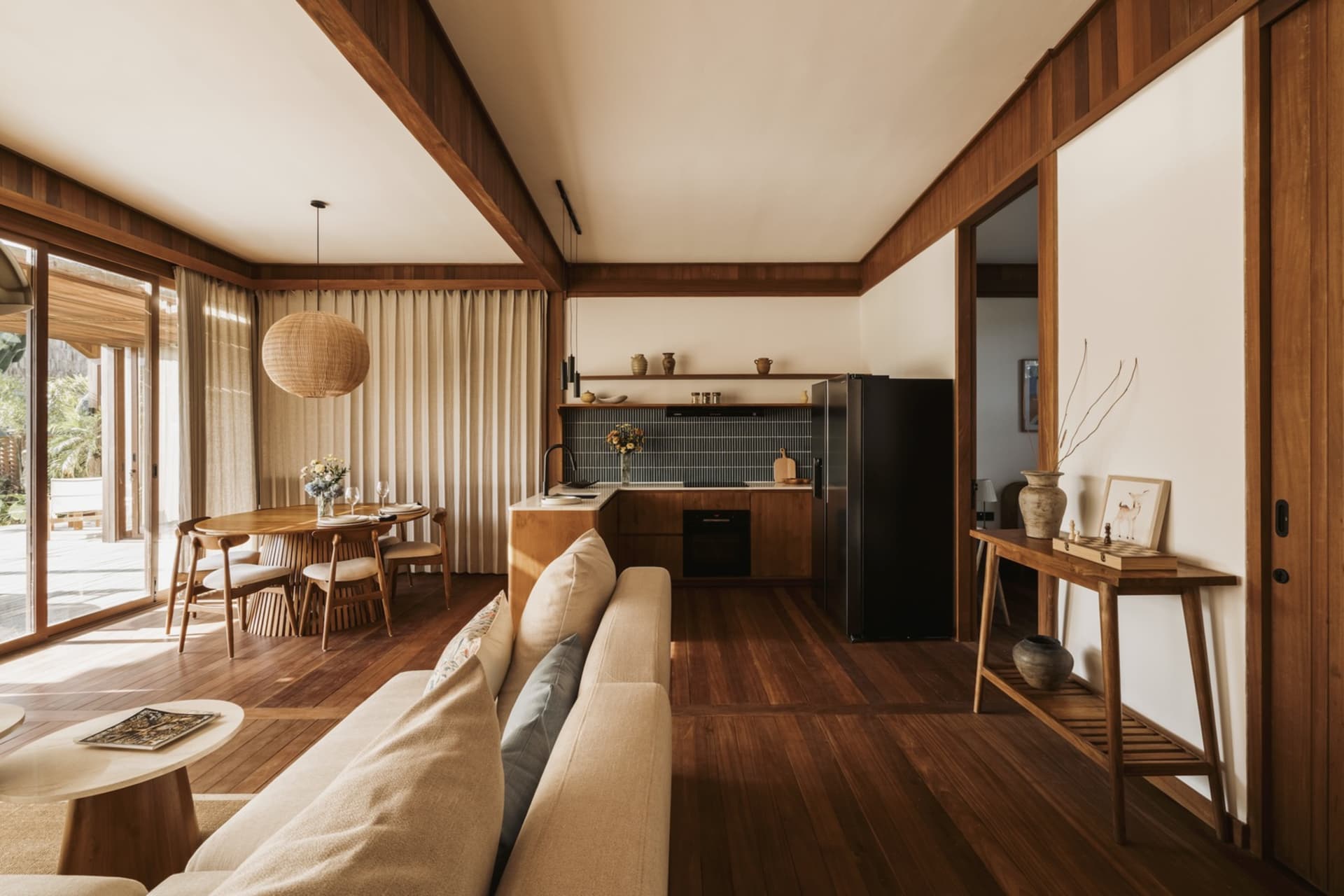 Modern residential interior with concrete flooring, wooden elements, and fabric furnishings.