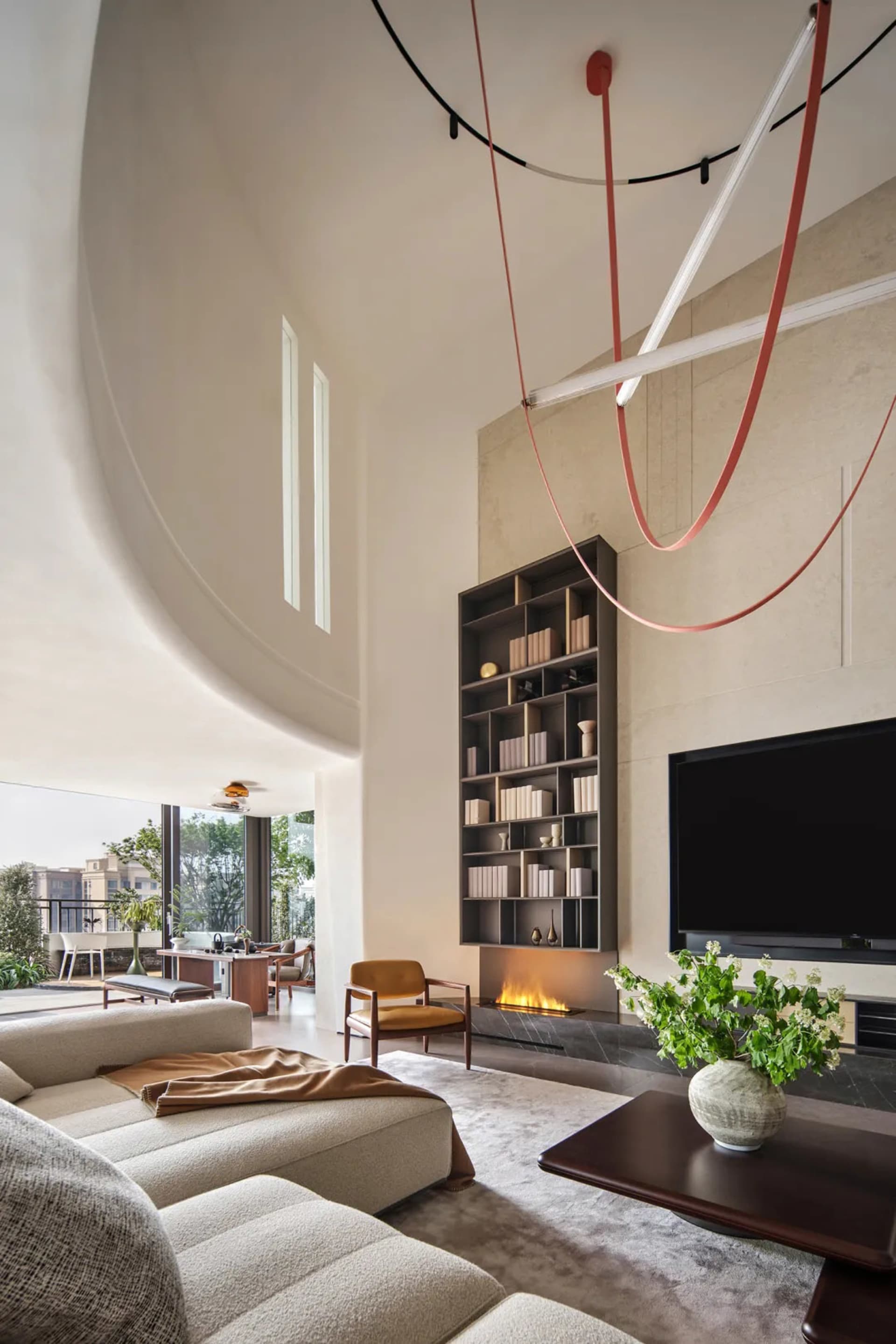 Modern living room with concrete walls, wooden ceiling, and a contemporary armchair.