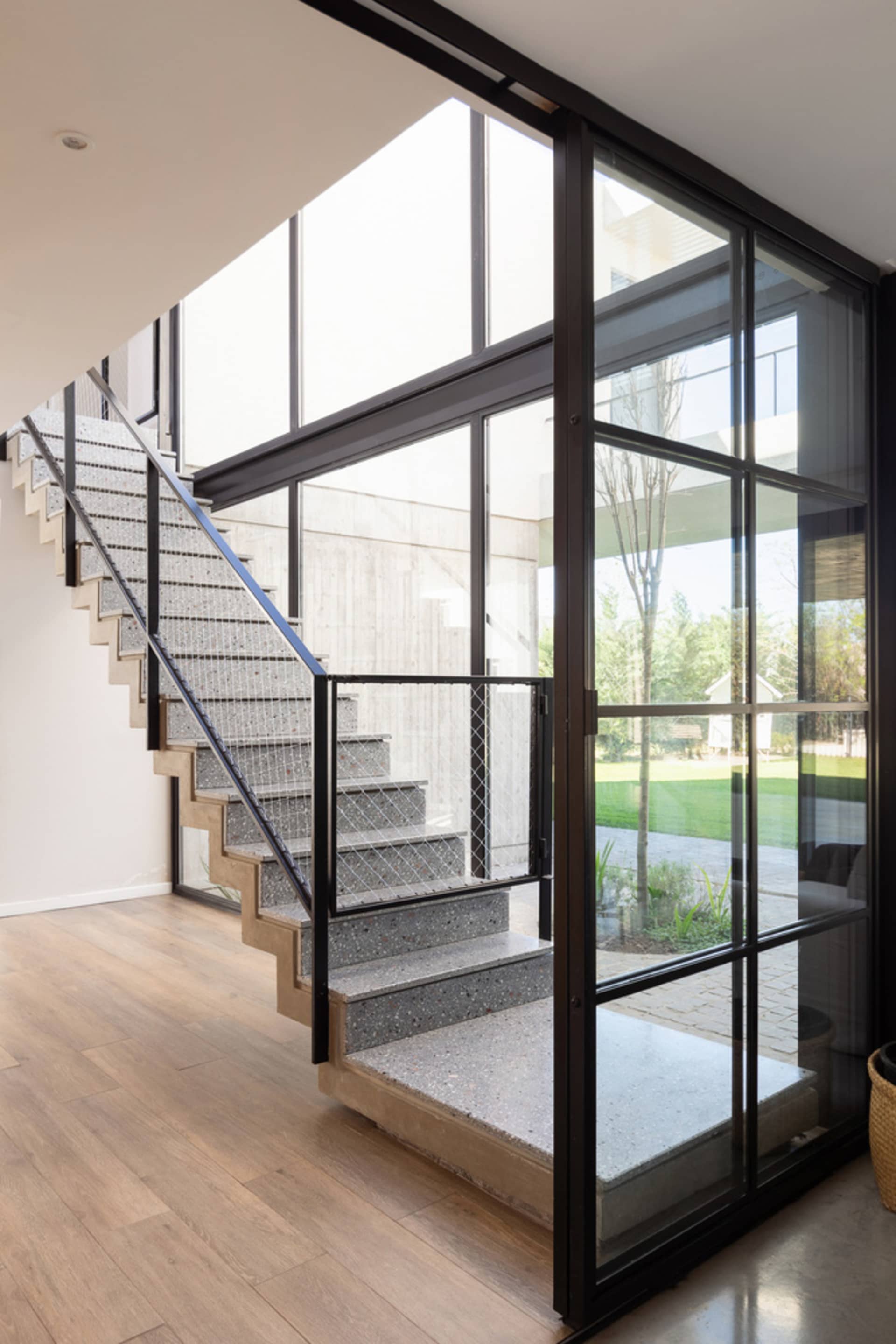 A modern living space featuring concrete and glass materials.