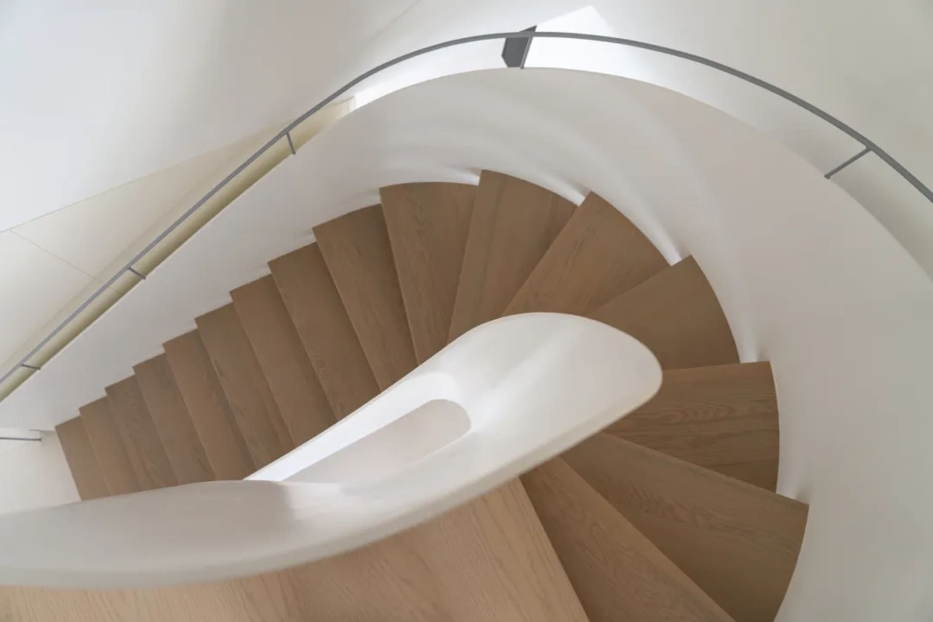 A minimalist staircase featuring wood and concrete materials.