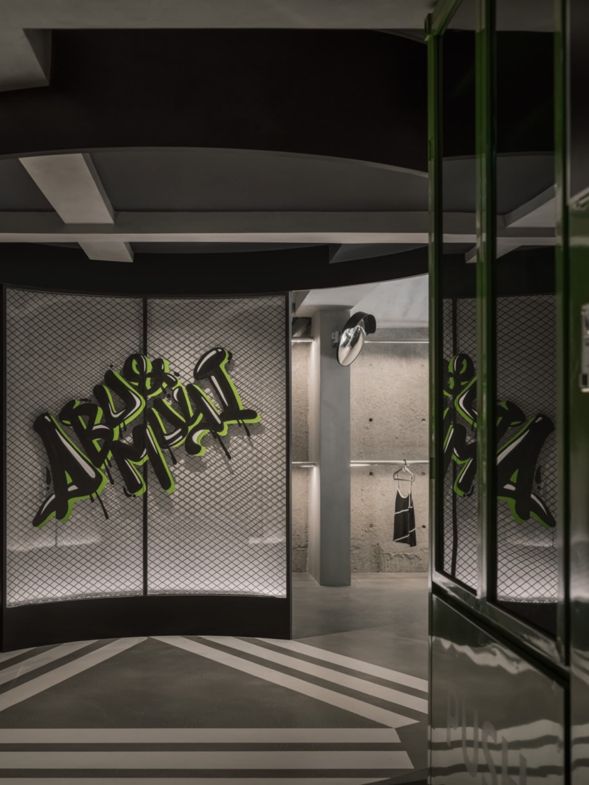 A modern retail shop featuring concrete walls with graffiti art, showcasing contemporary interior design elements.