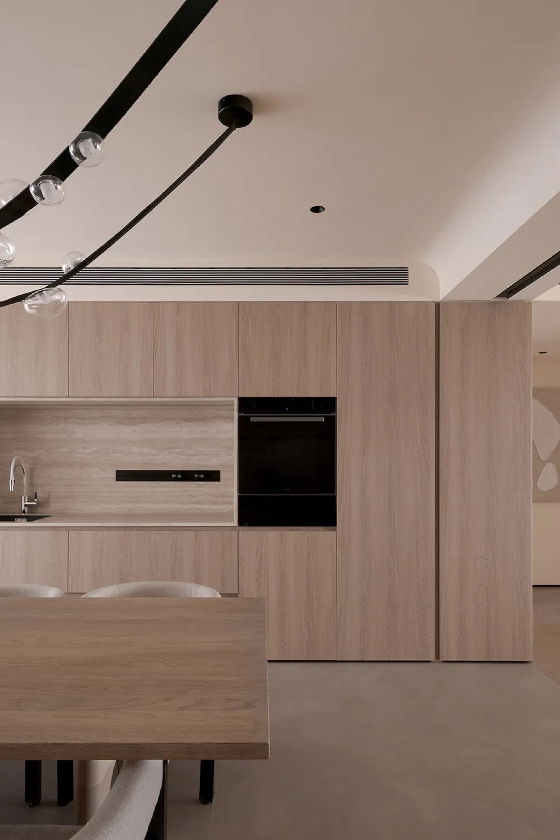 A minimalist kitchen with tiled flooring and wooden countertops.