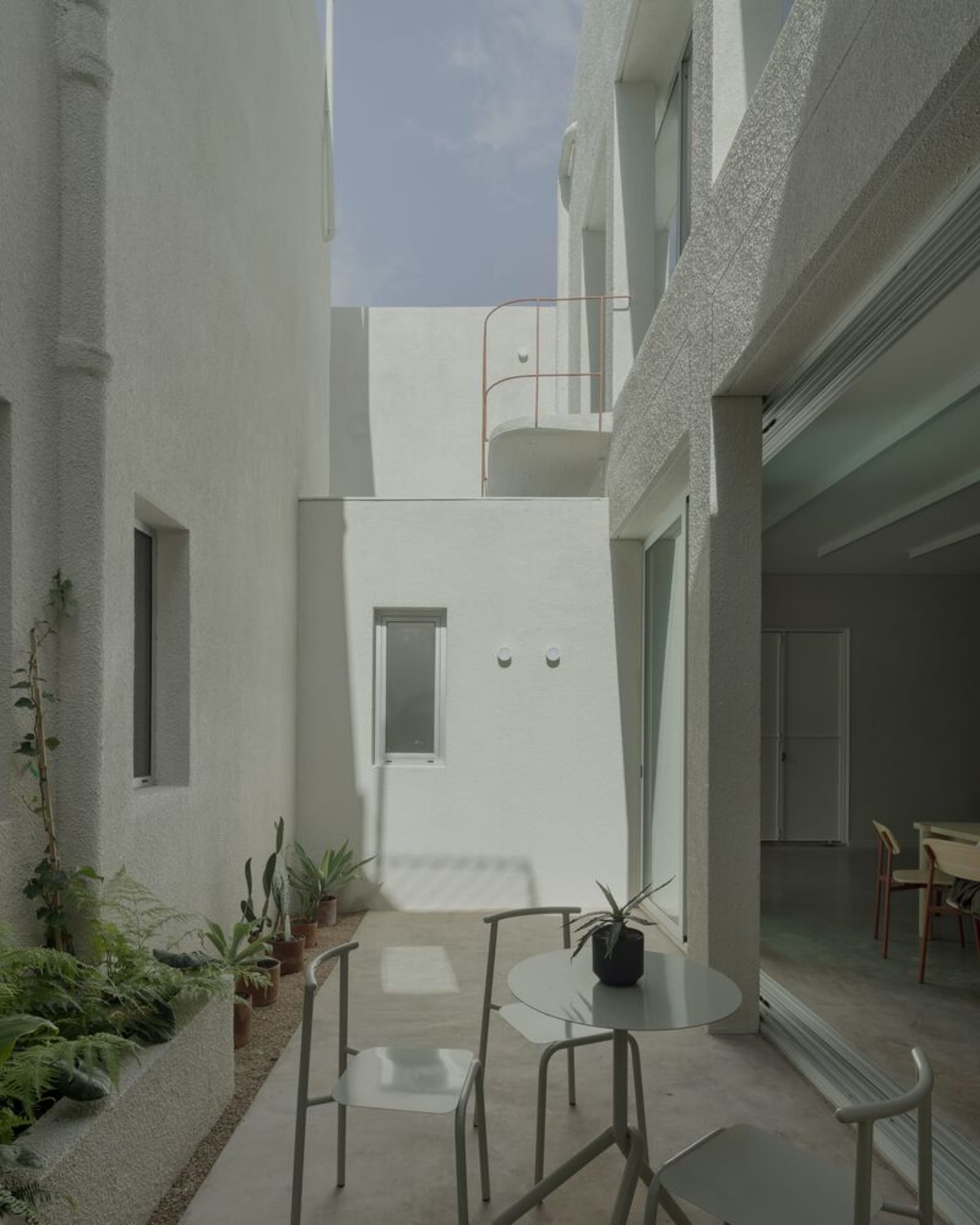 Modern, minimalist interior with white walls and concrete finishes