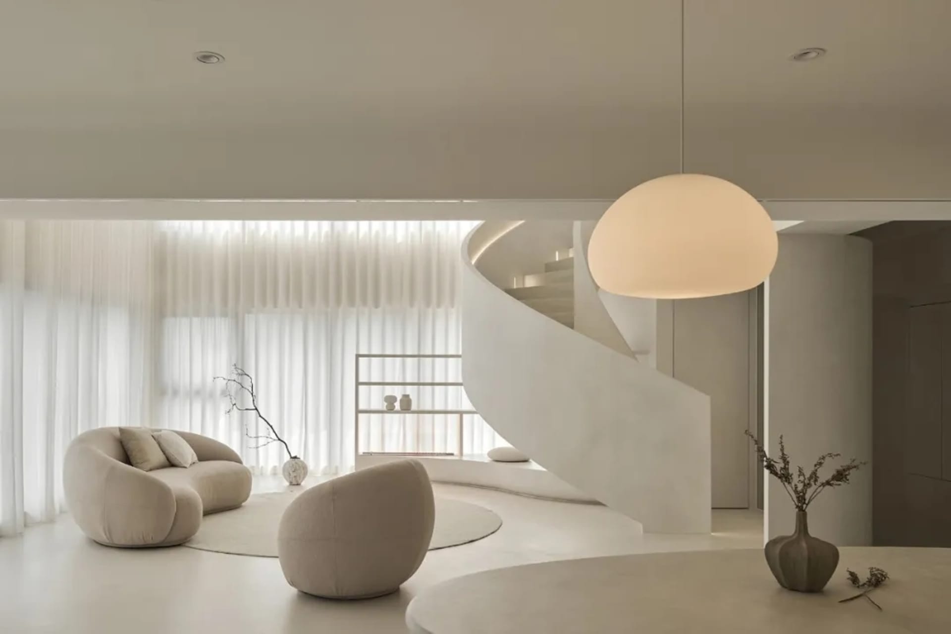 Modern living room with minimalist design and concrete floor.