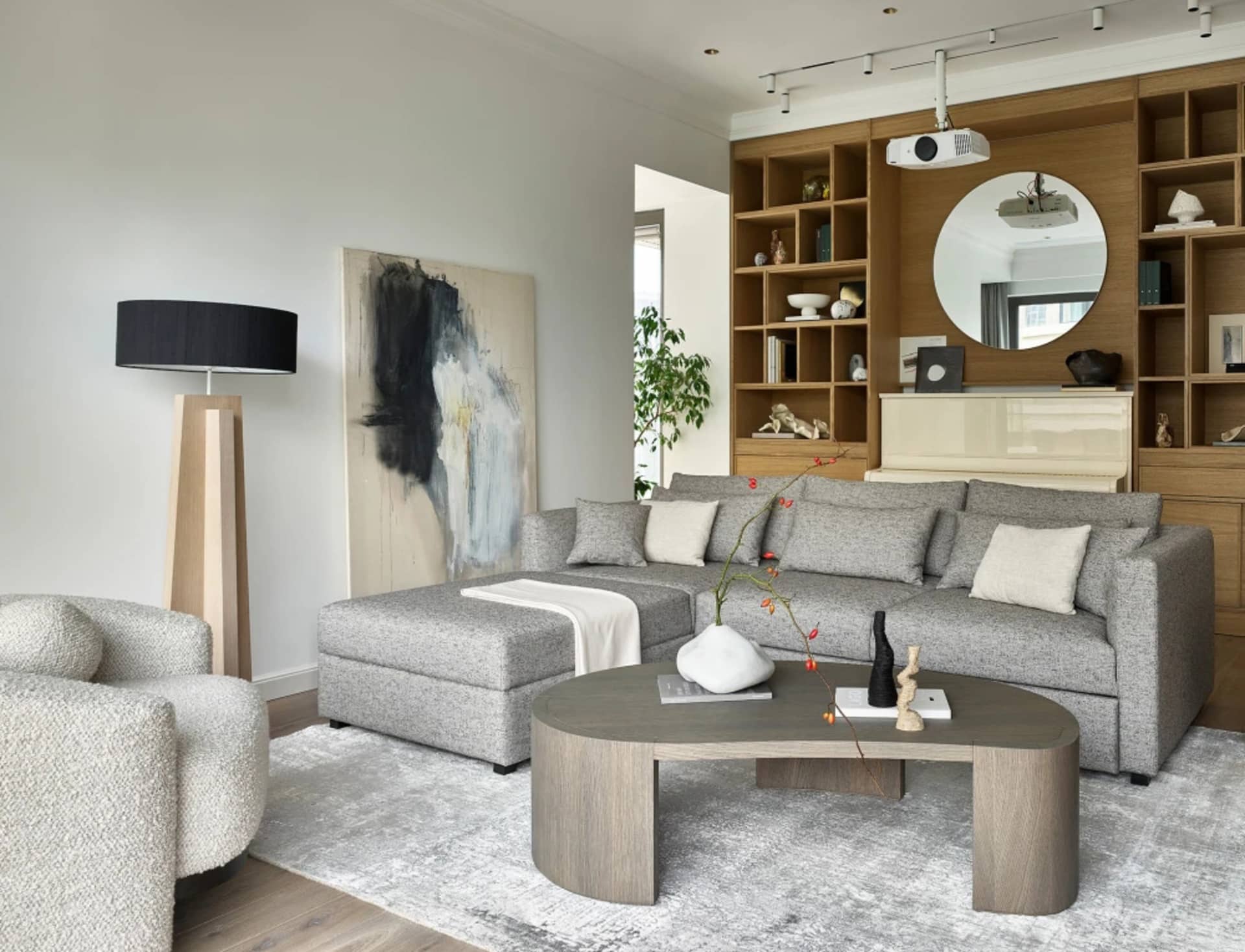 A modern living room featuring mixed materials and plush seating.