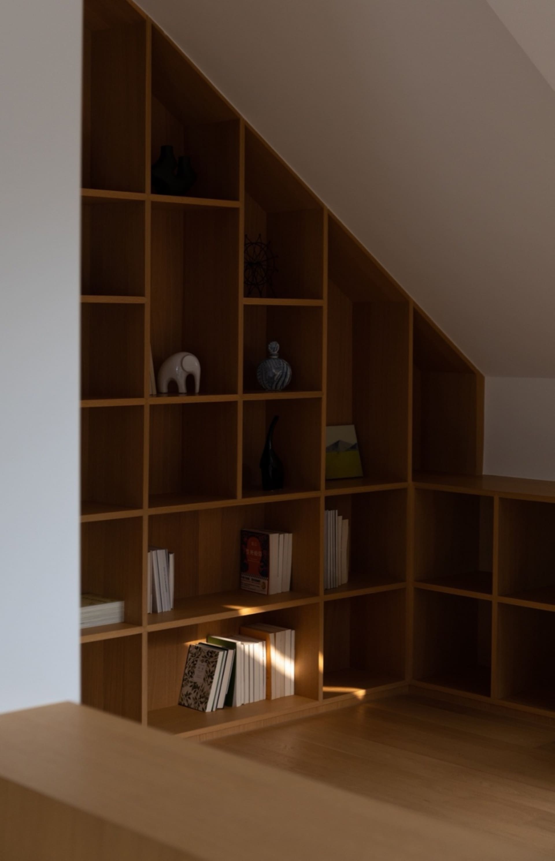 A modern bookshelf filled with books and decorative items.