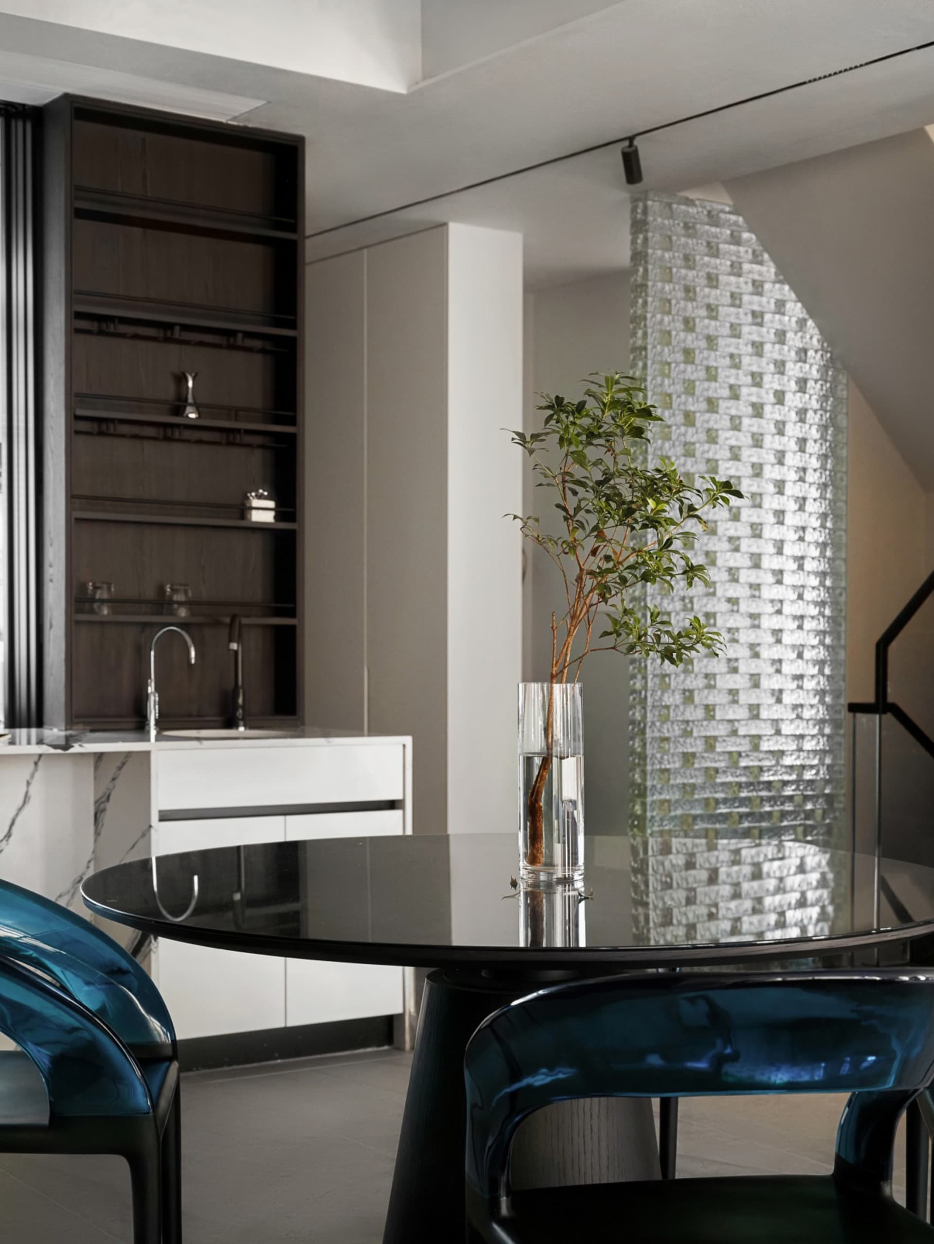 A photograph of a modern kitchen featuring transparent glass elements.