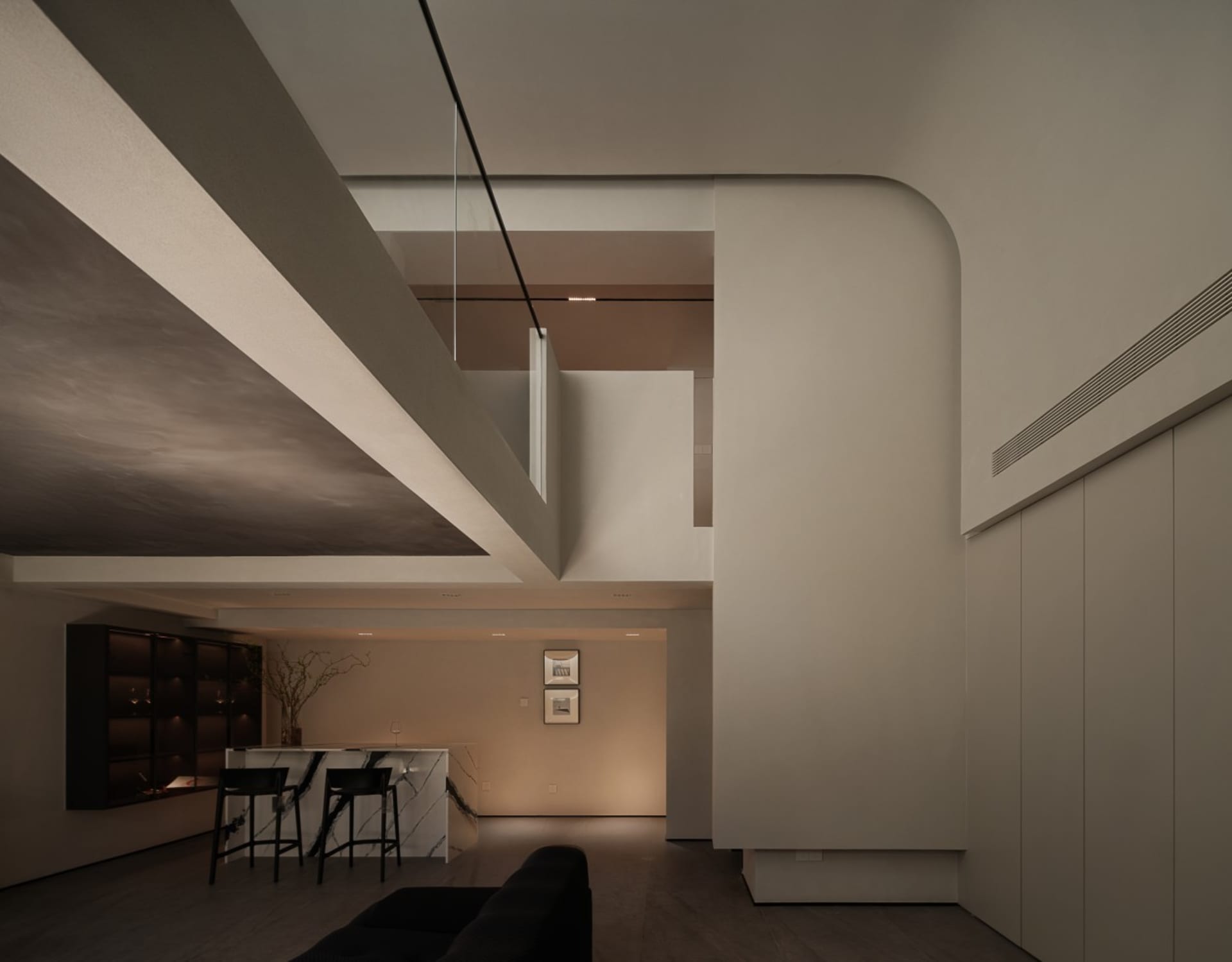 Modern residential space featuring concrete, marble, and glass materials.