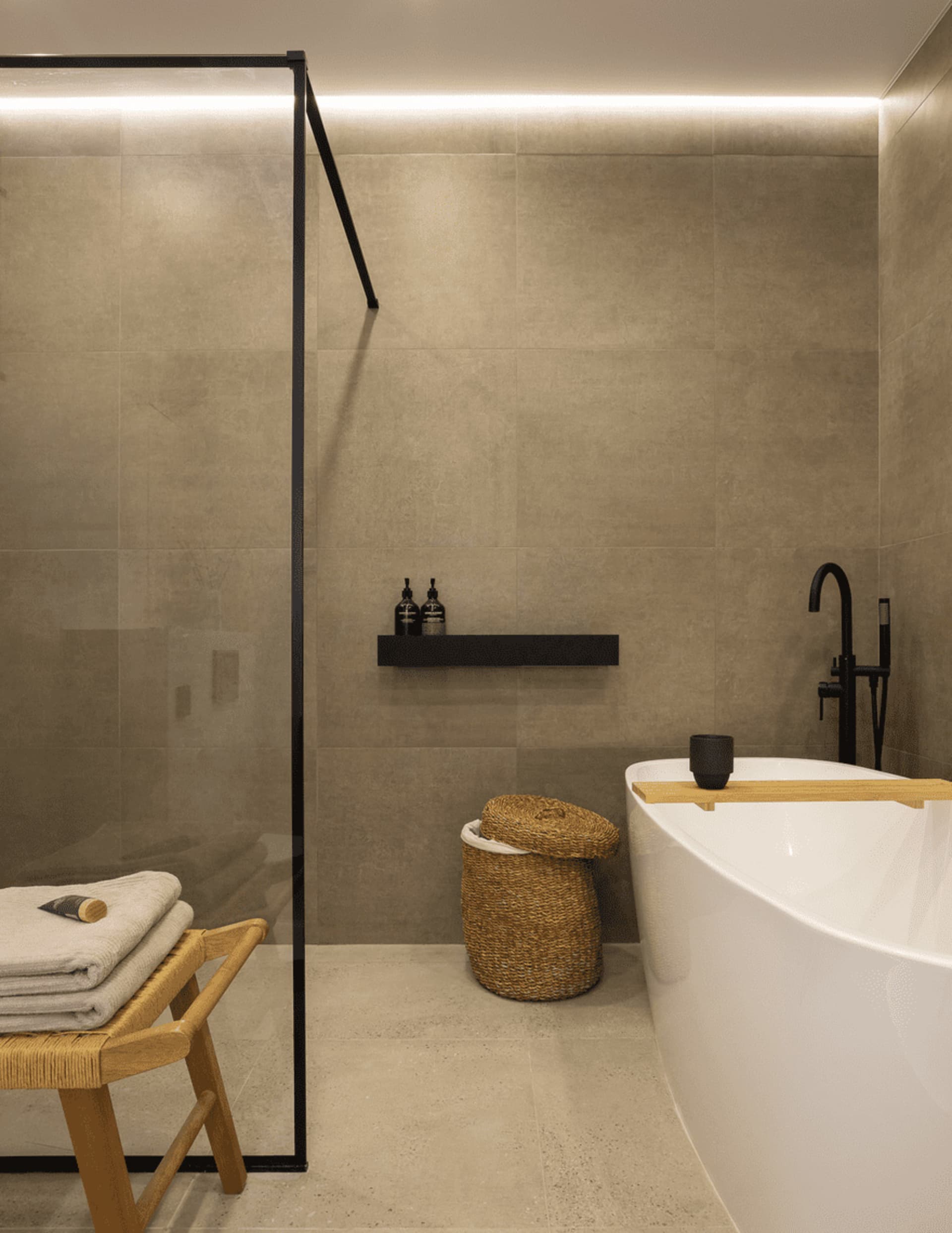 Modern minimalist bathroom with marble and stone tiles.