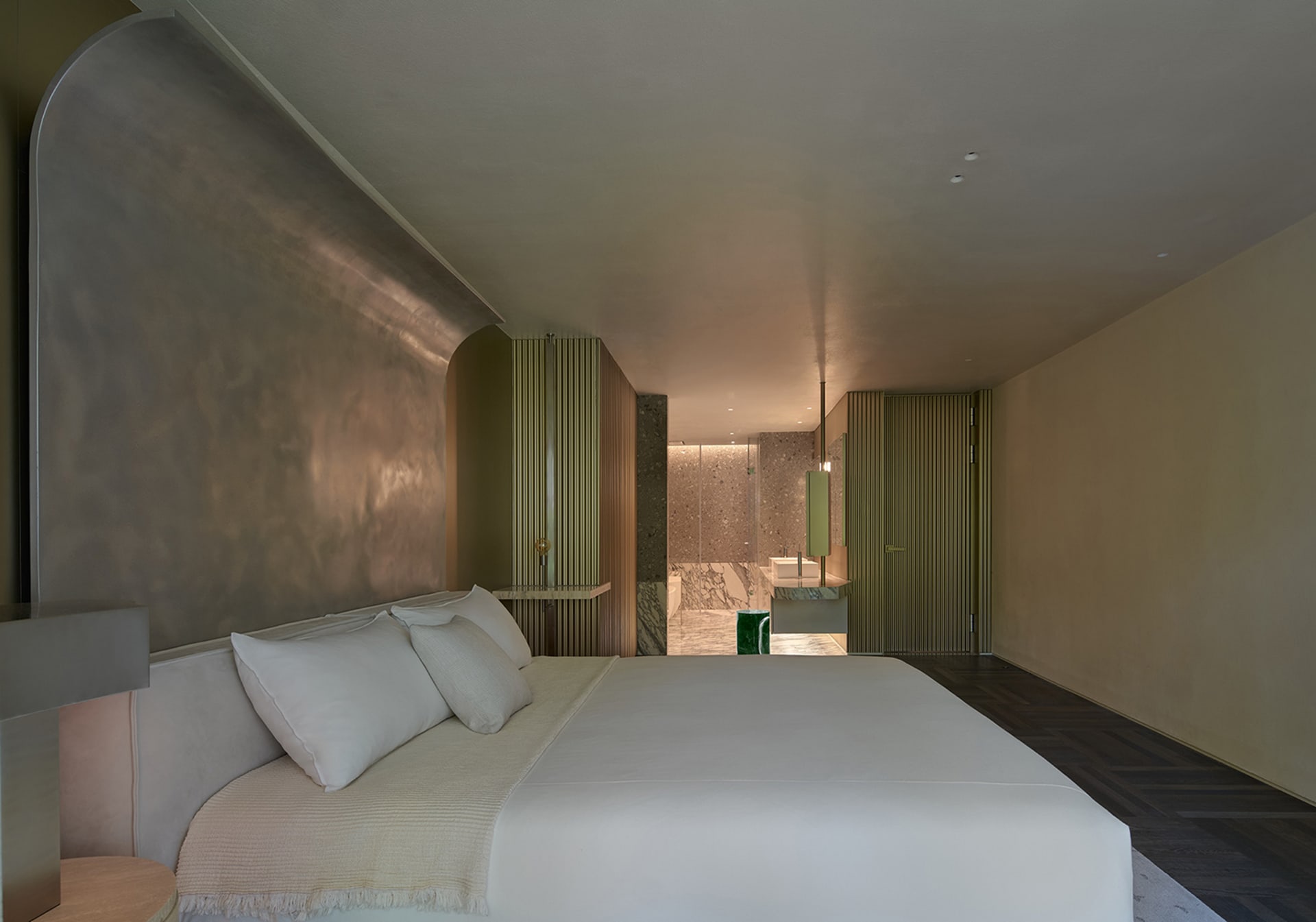 A modern bedroom with neutral-toned materials and a minimalist design.
