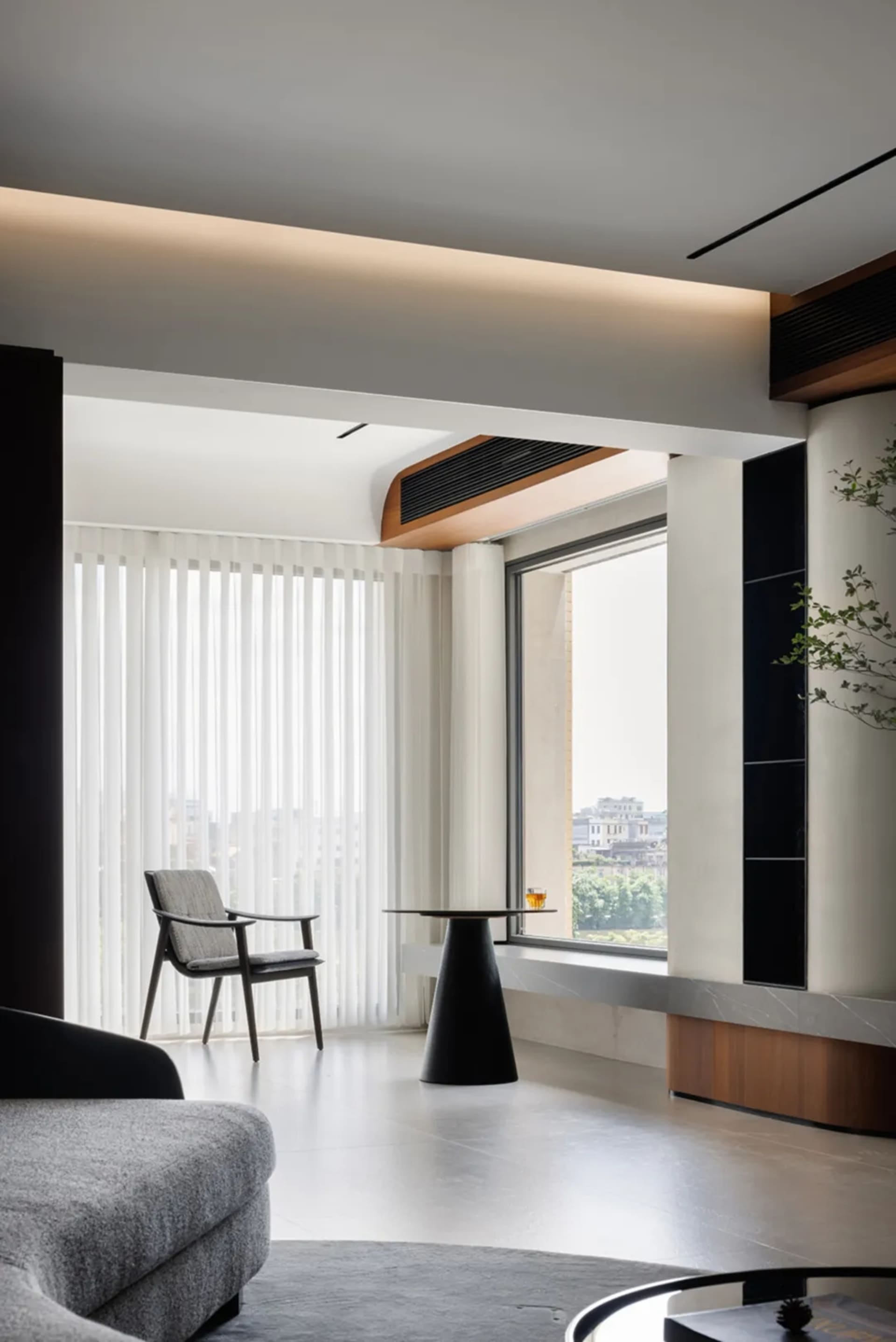 Modern interior design of a living room featuring a large window with vertical blinds.