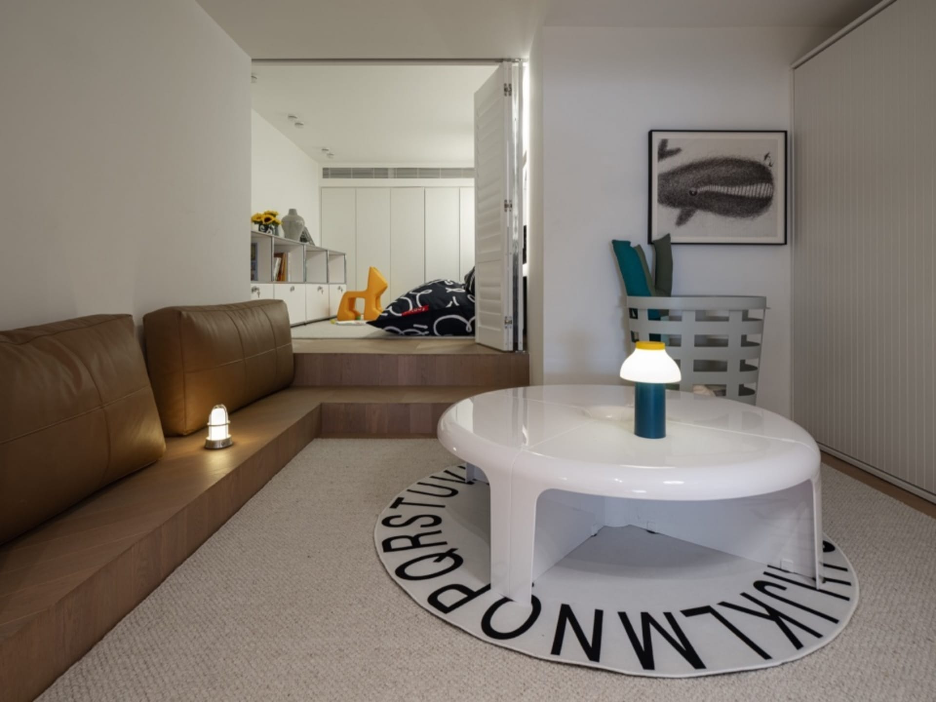 A modern living room with a round table and a sofa.
