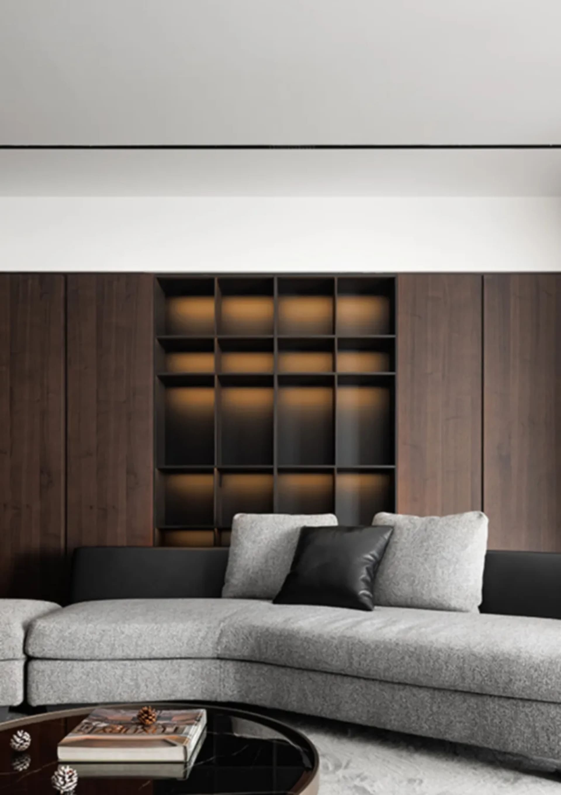 Modern living room with wooden paneled backdrop, featuring a cozy arrangement of contemporary furniture and lighting.