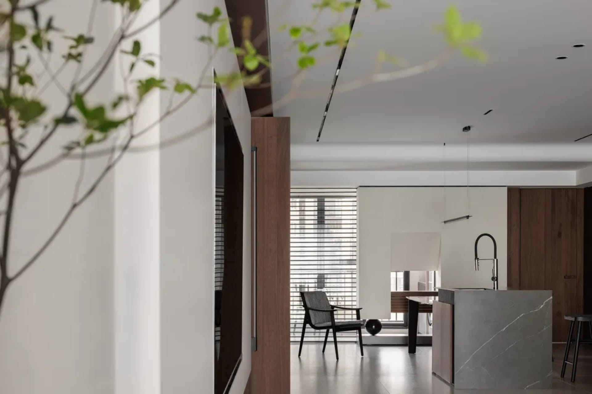 Modern residential interior with concrete, glass, and wooden elements.