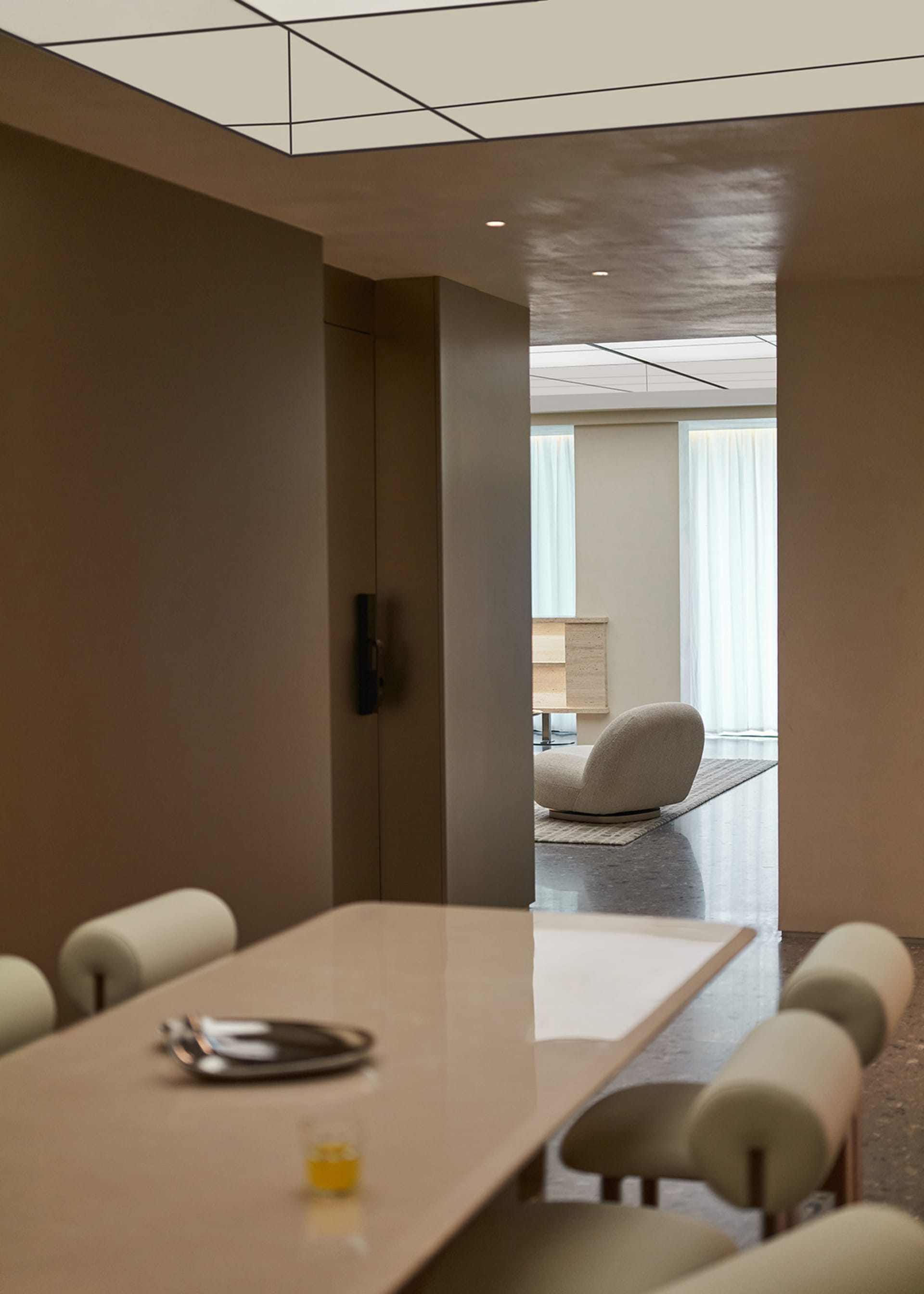 Modern residential interior space with minimalist furniture and neutral color palette.