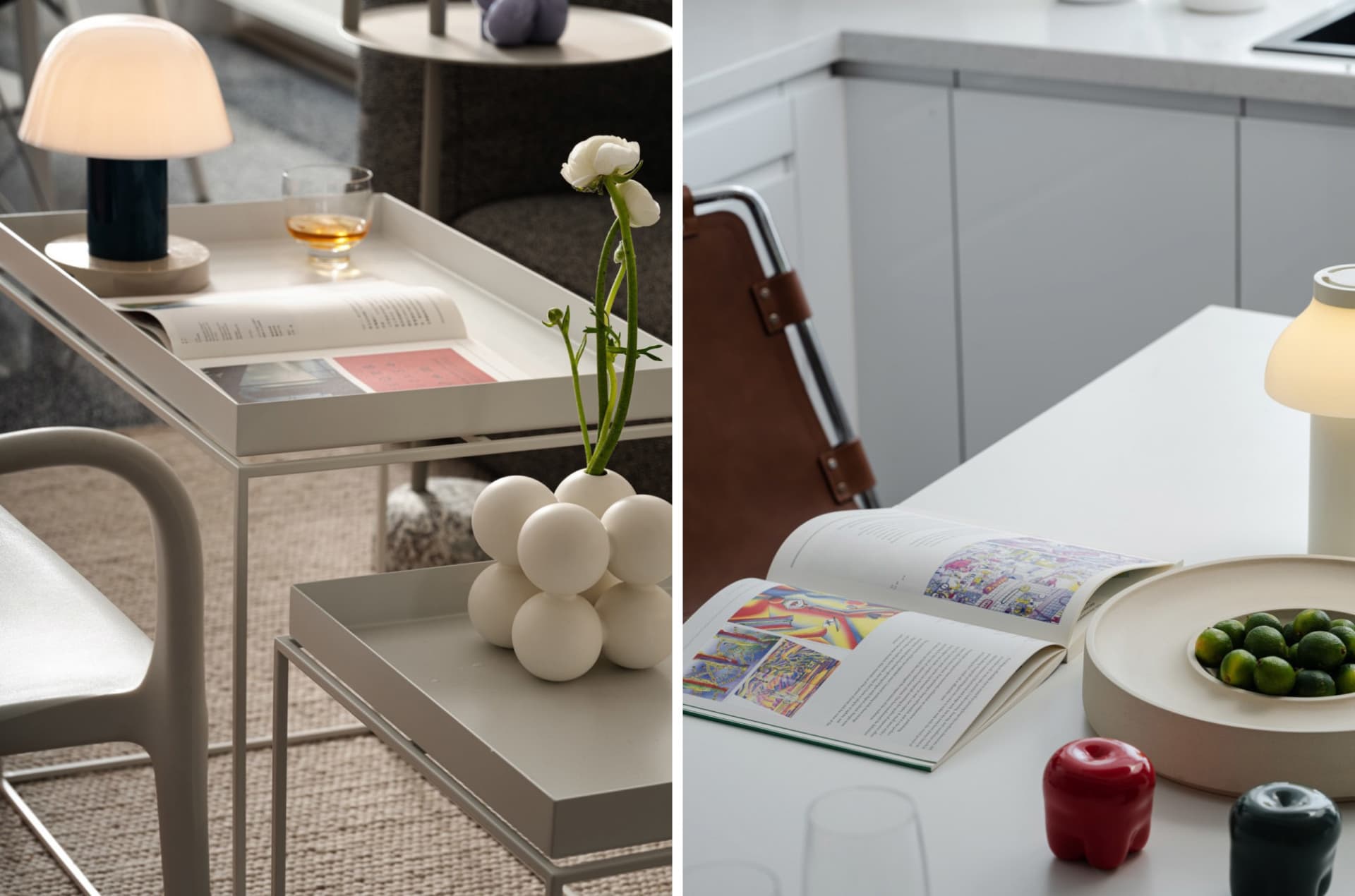 A modern kitchen with minimalist design, featuring white countertops and a white table with a vase of flowers and a book.