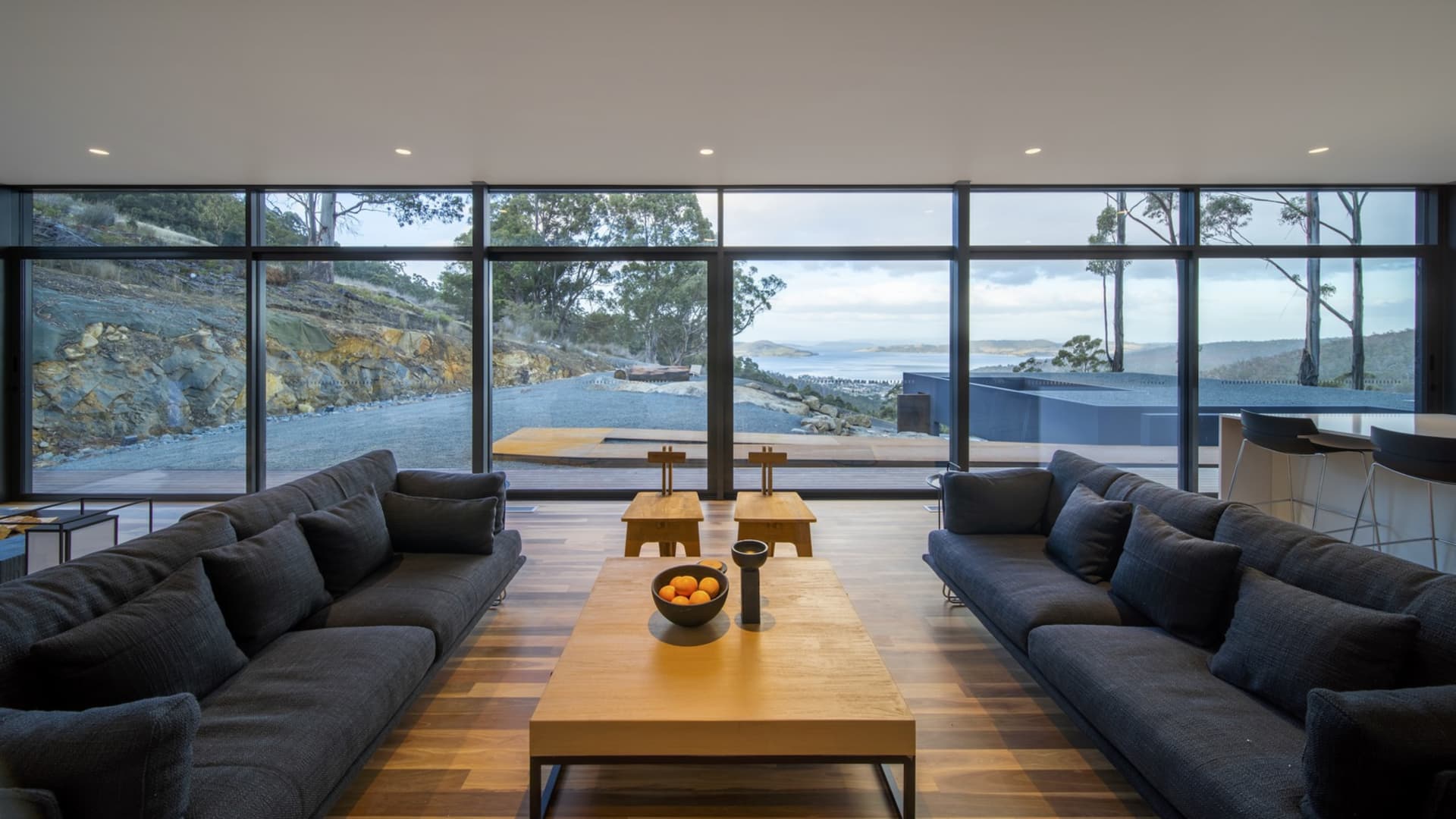 Modern living room featuring wooden furniture and a view of the outdoors.