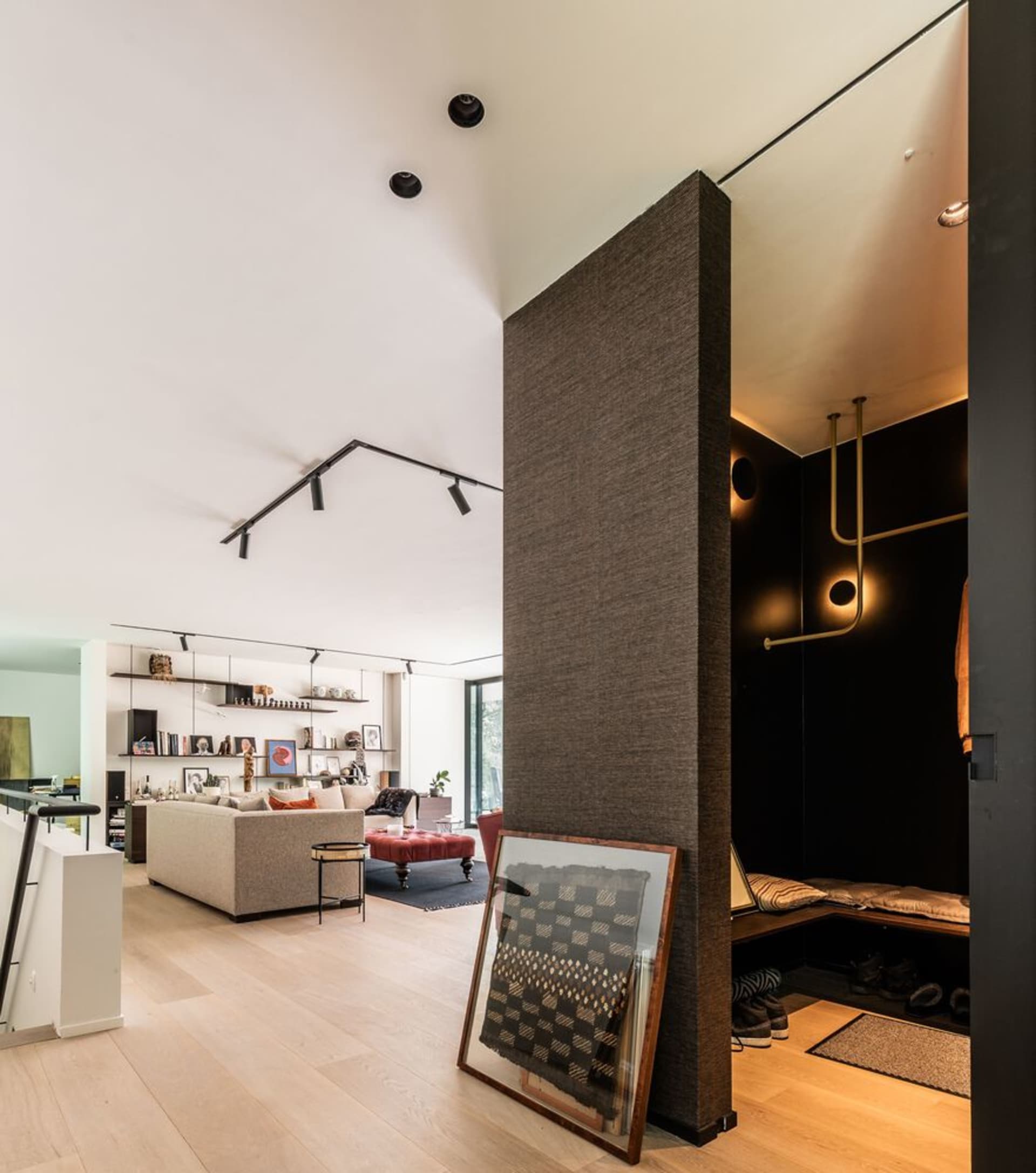 Modern interior design featuring mixed media elements such as wood, metal, and fabric in a living area.