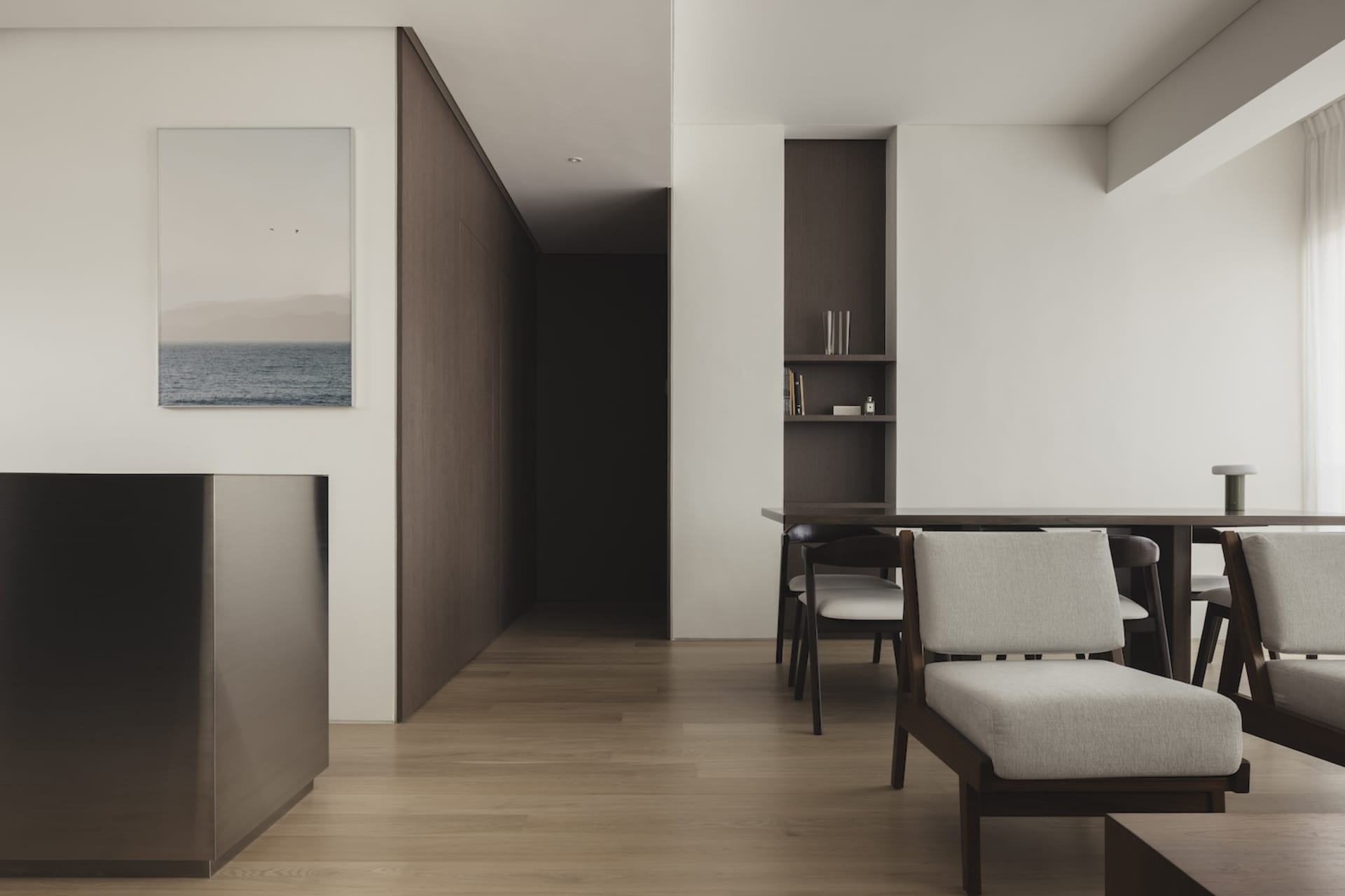 Modern minimalist living room with wooden furniture, fabric upholstery, and metal accents.
