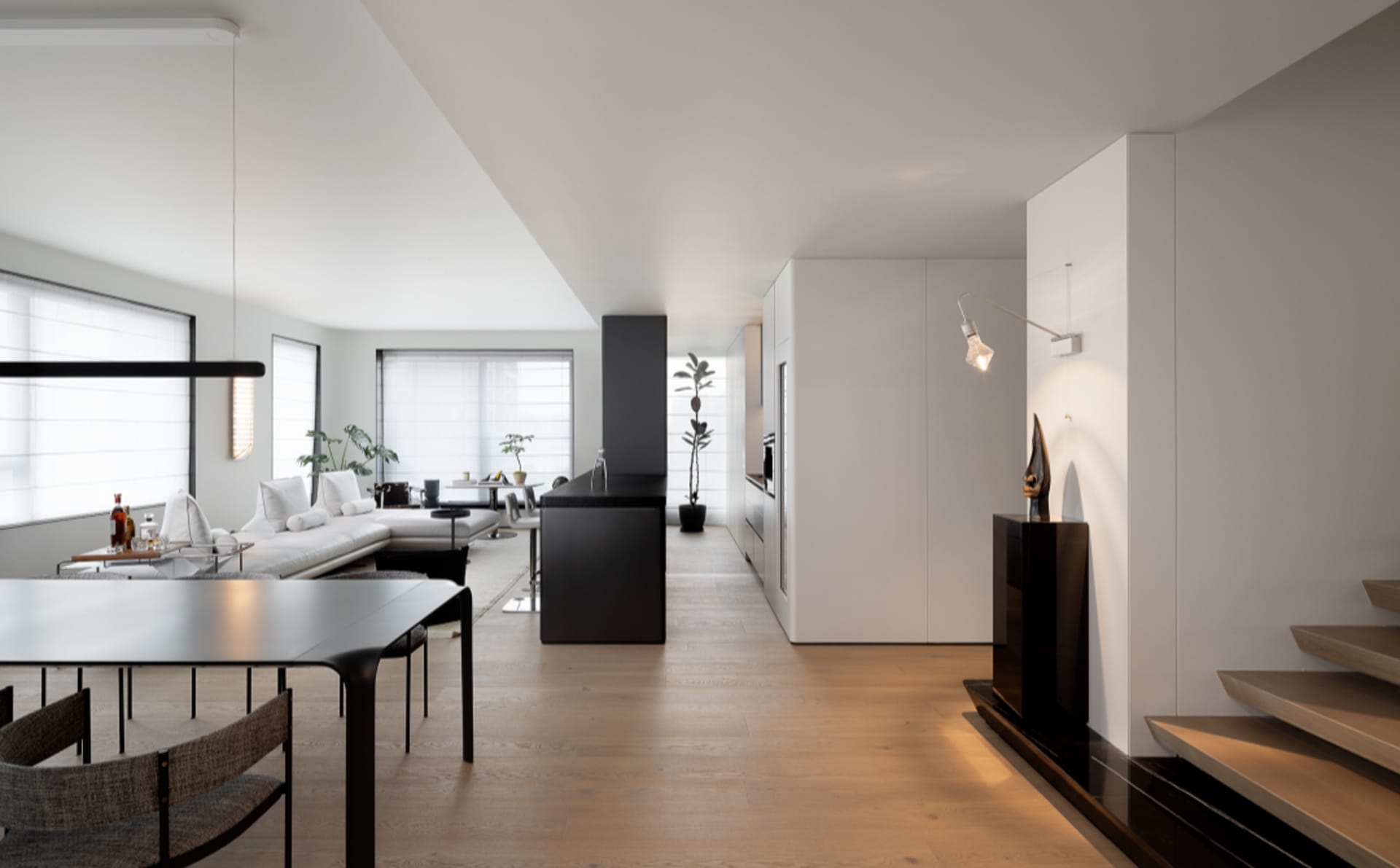 A modern minimalist apartment showcasing sleek design features and functional zones.