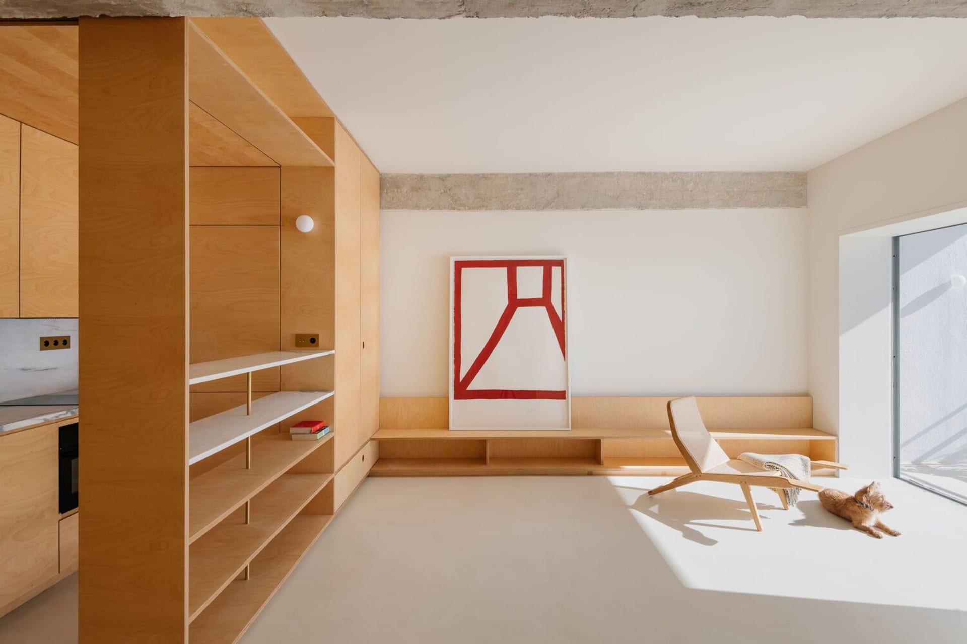 A minimalist living area with a wooden feature wall and a geometric art piece.