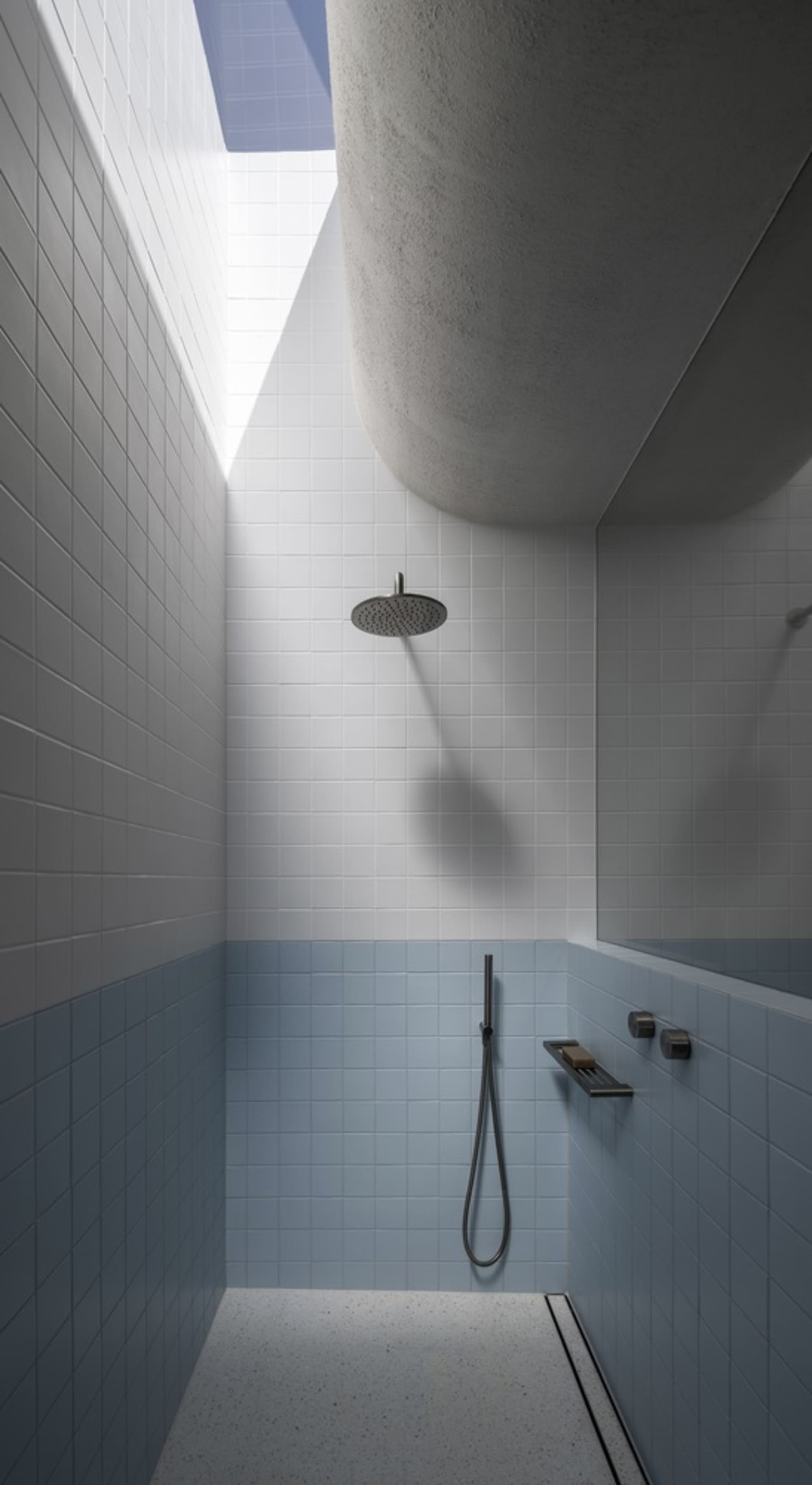 Modern bathroom with white and grey ceramic tiles and concrete roof