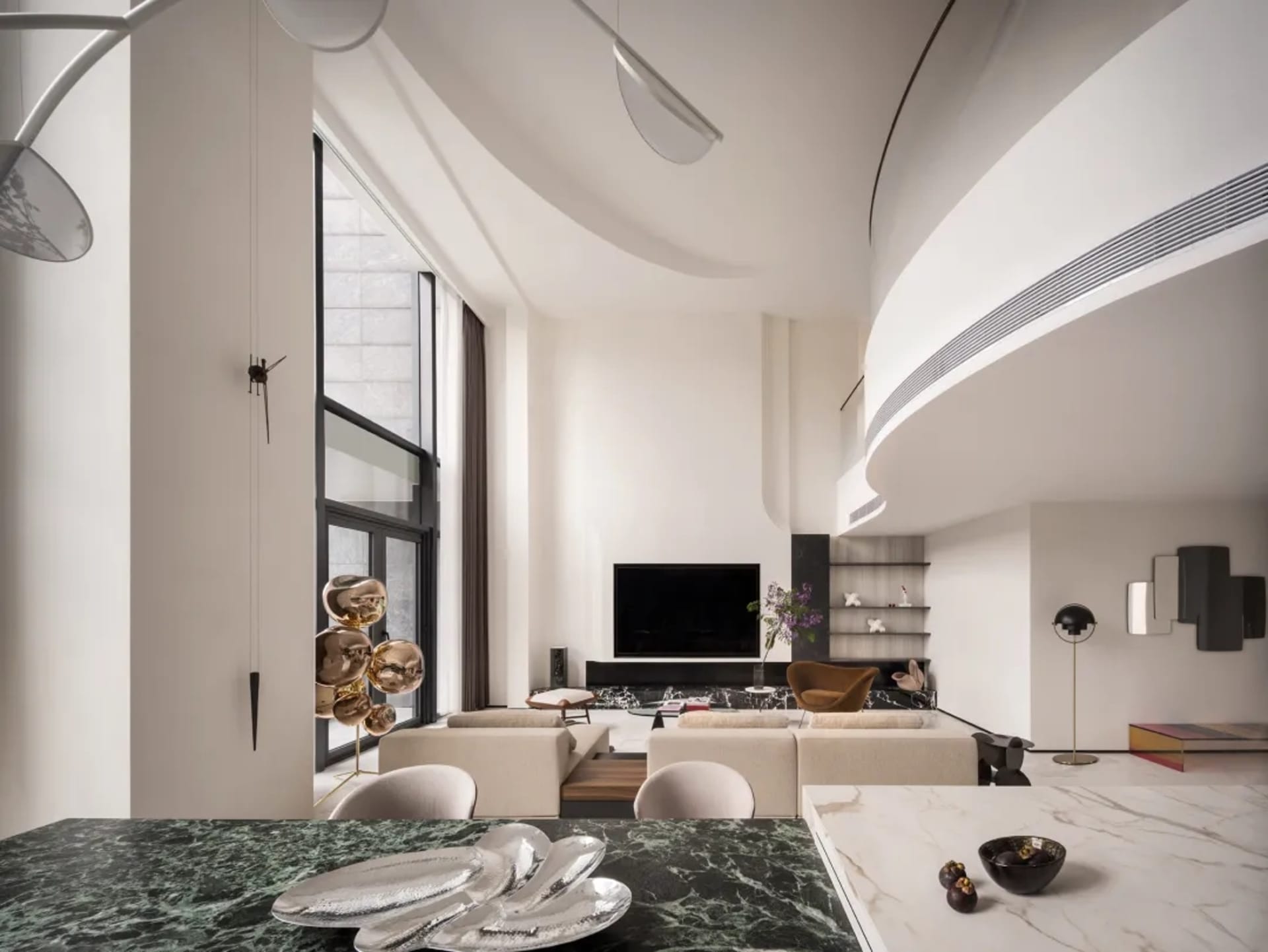 Modern living room featuring a marble dining table, stainless-steel chairs, and wooden furniture.