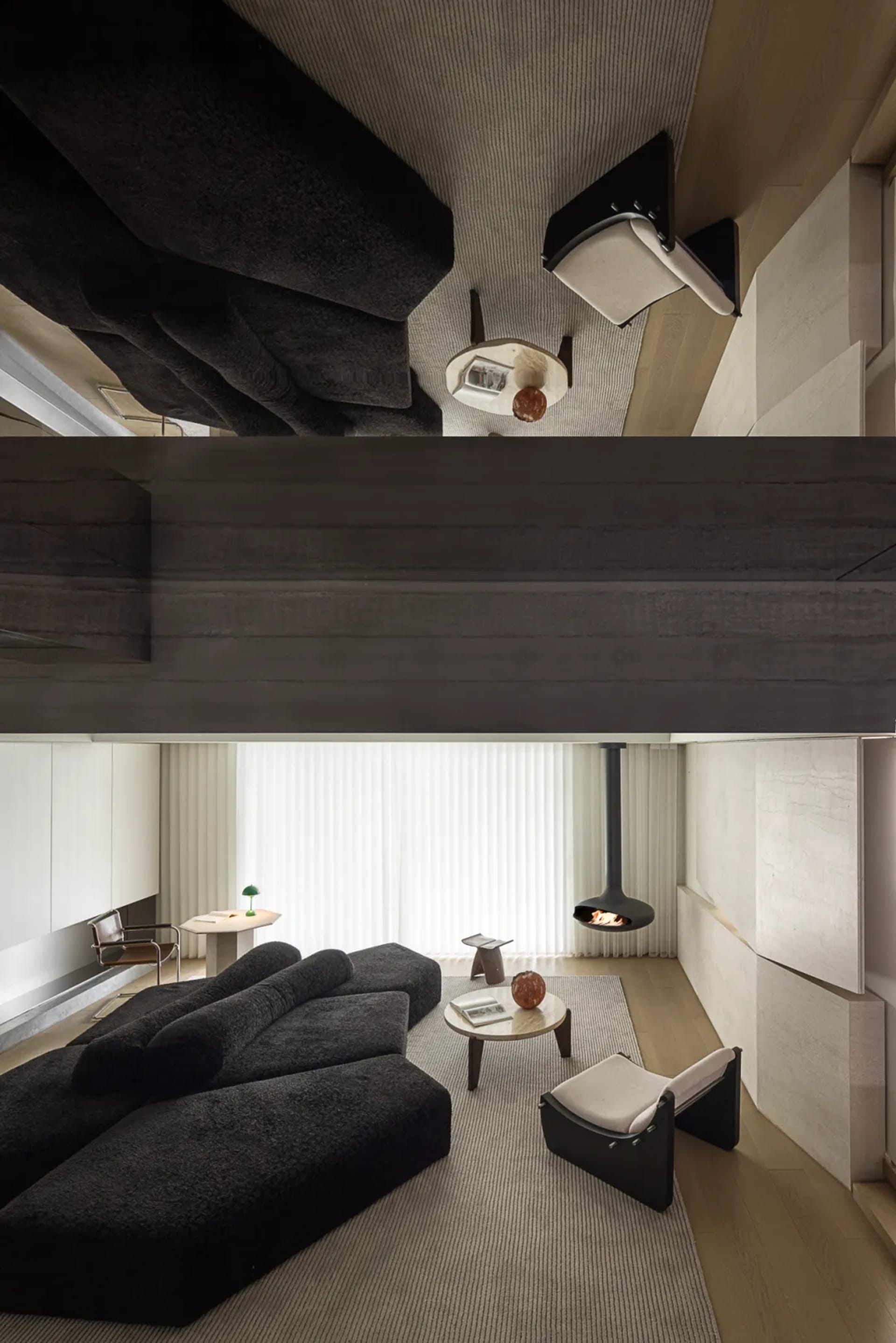 Modern living room featuring a black sectional sofa, wooden coffee table, and a wall-mounted fireplace.