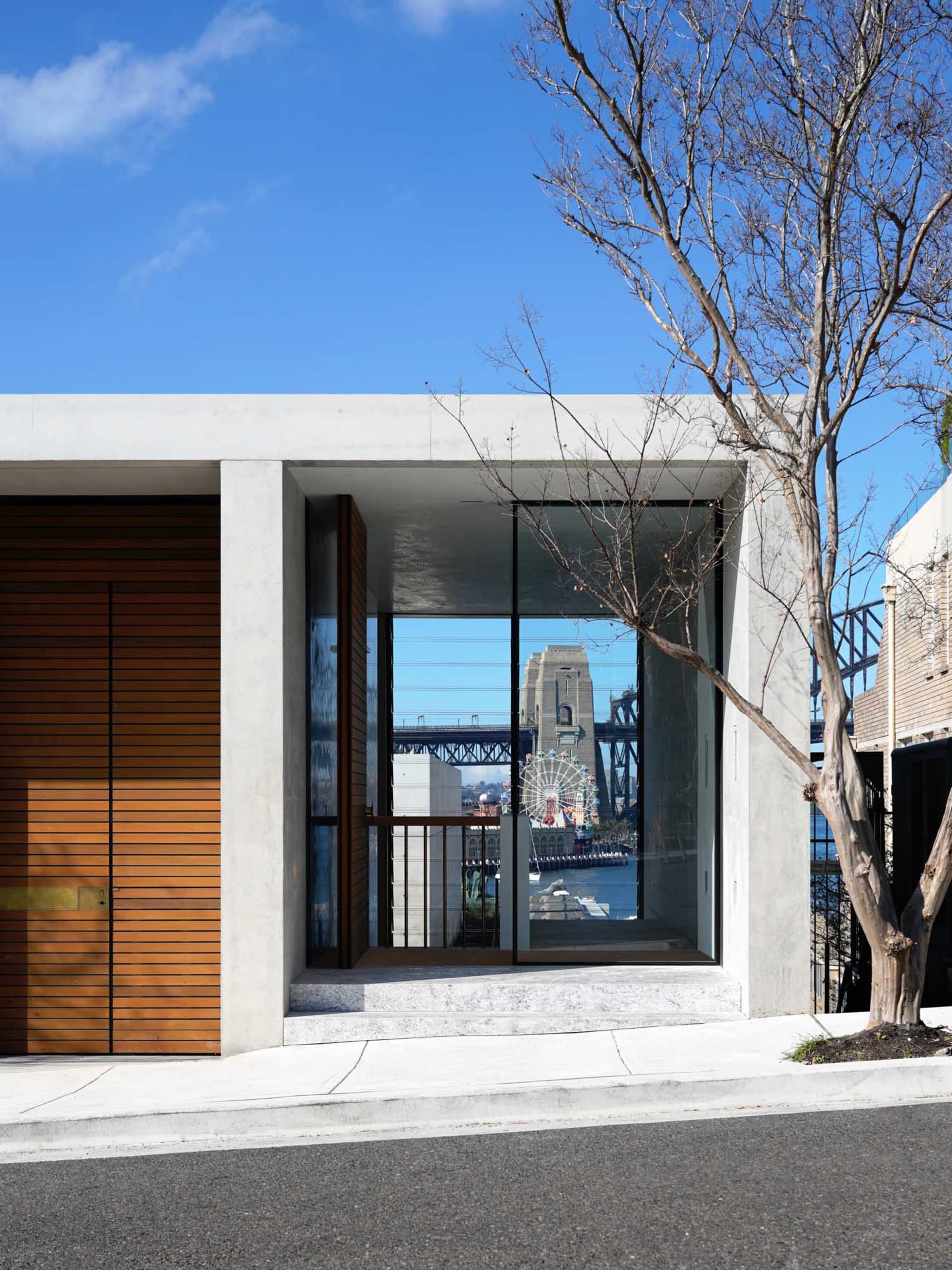 Modern entrance with concrete materials and large glass panels.