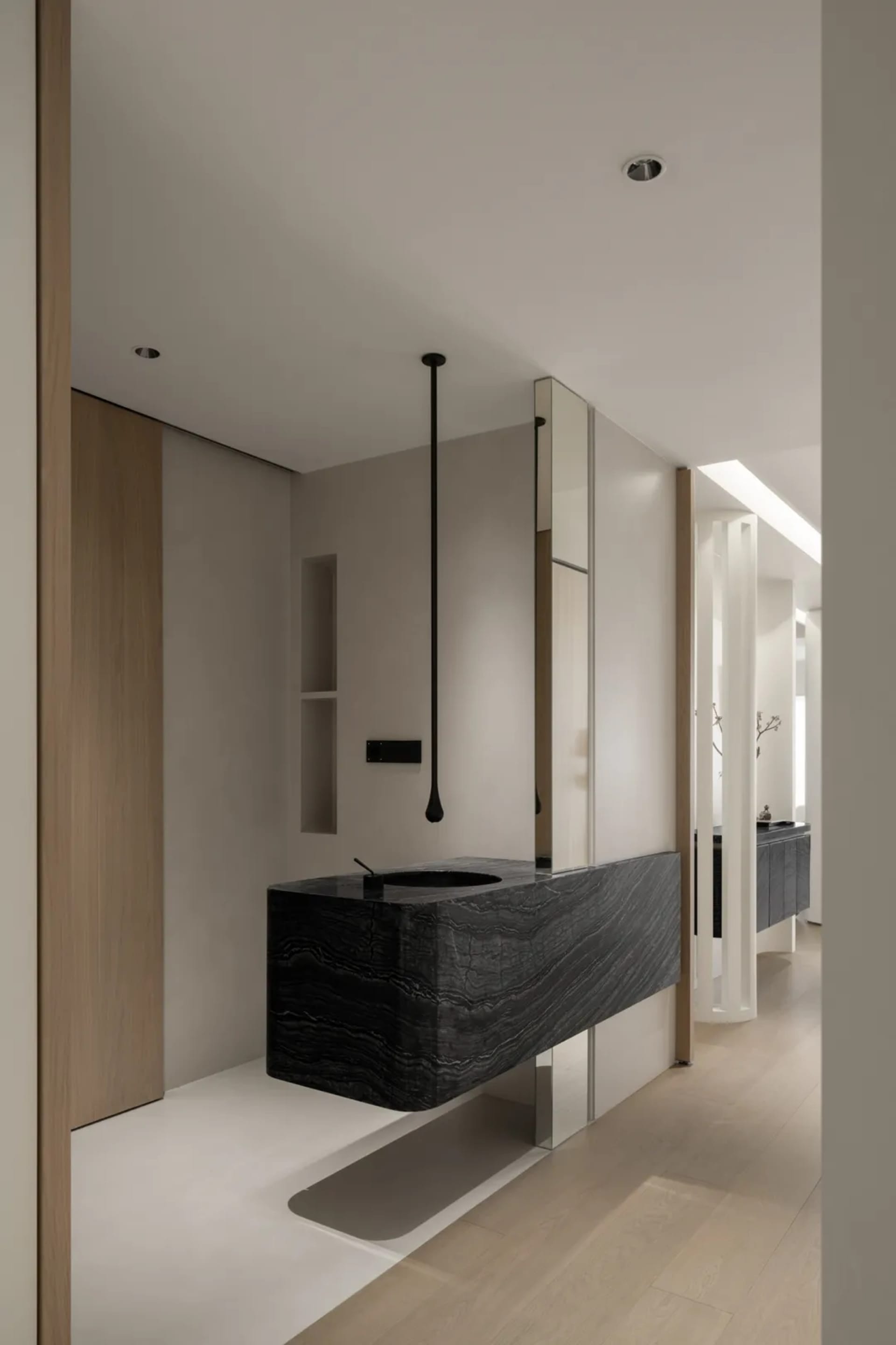 A modern, minimalist bathroom featuring black metal fixtures and a sleek, contemporary design.