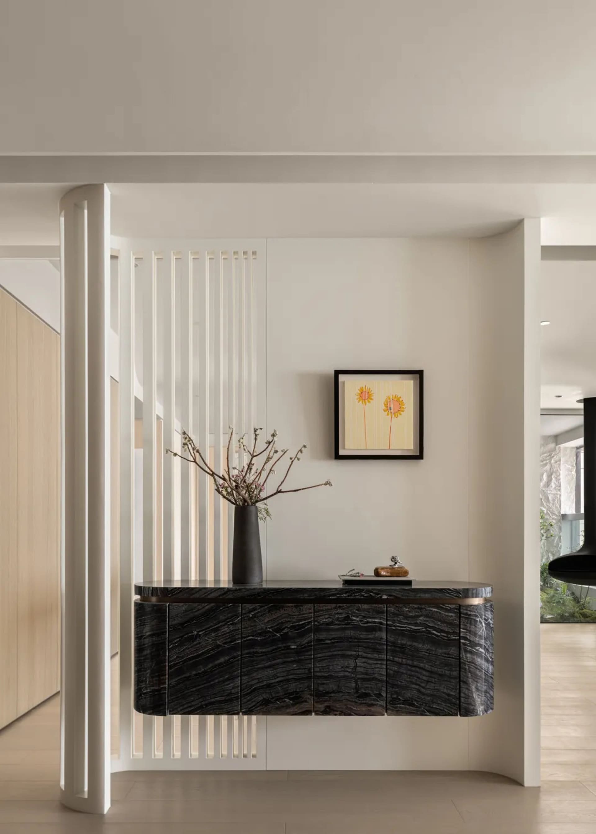 Contemporary entrance area featuring marble furniture and minimalistic design.